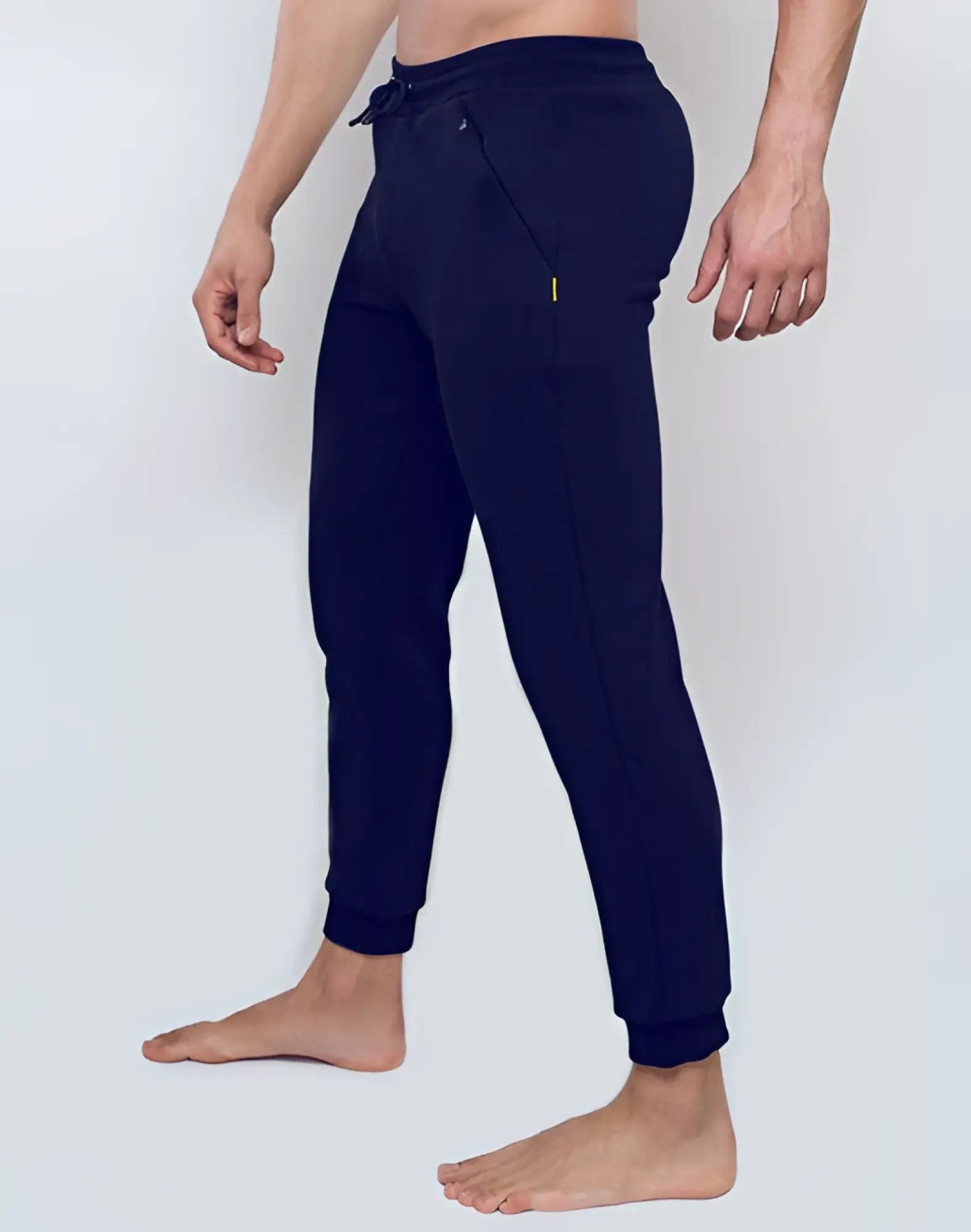 Dark navy supawear recovery jogger pants with drawstring waist and neon yellow zipper pulls for active wear
