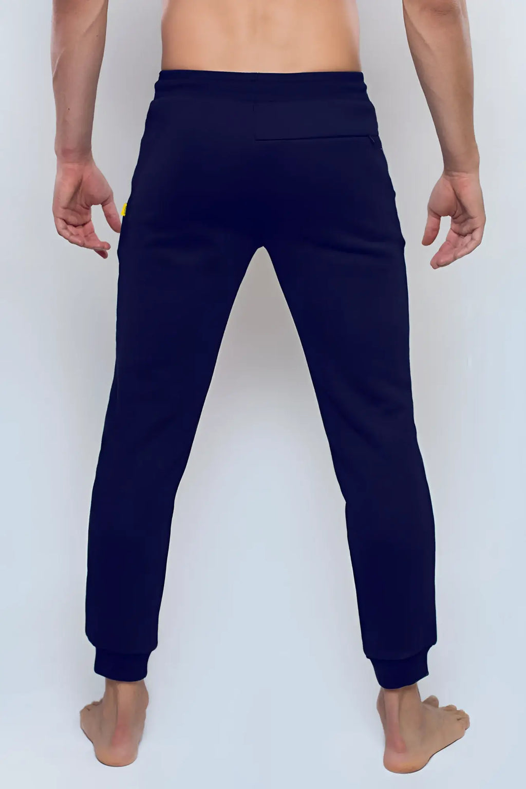 Navy blue supawear recovery jogger pants with subtle yellow logo on left thigh designed for comfort and performance