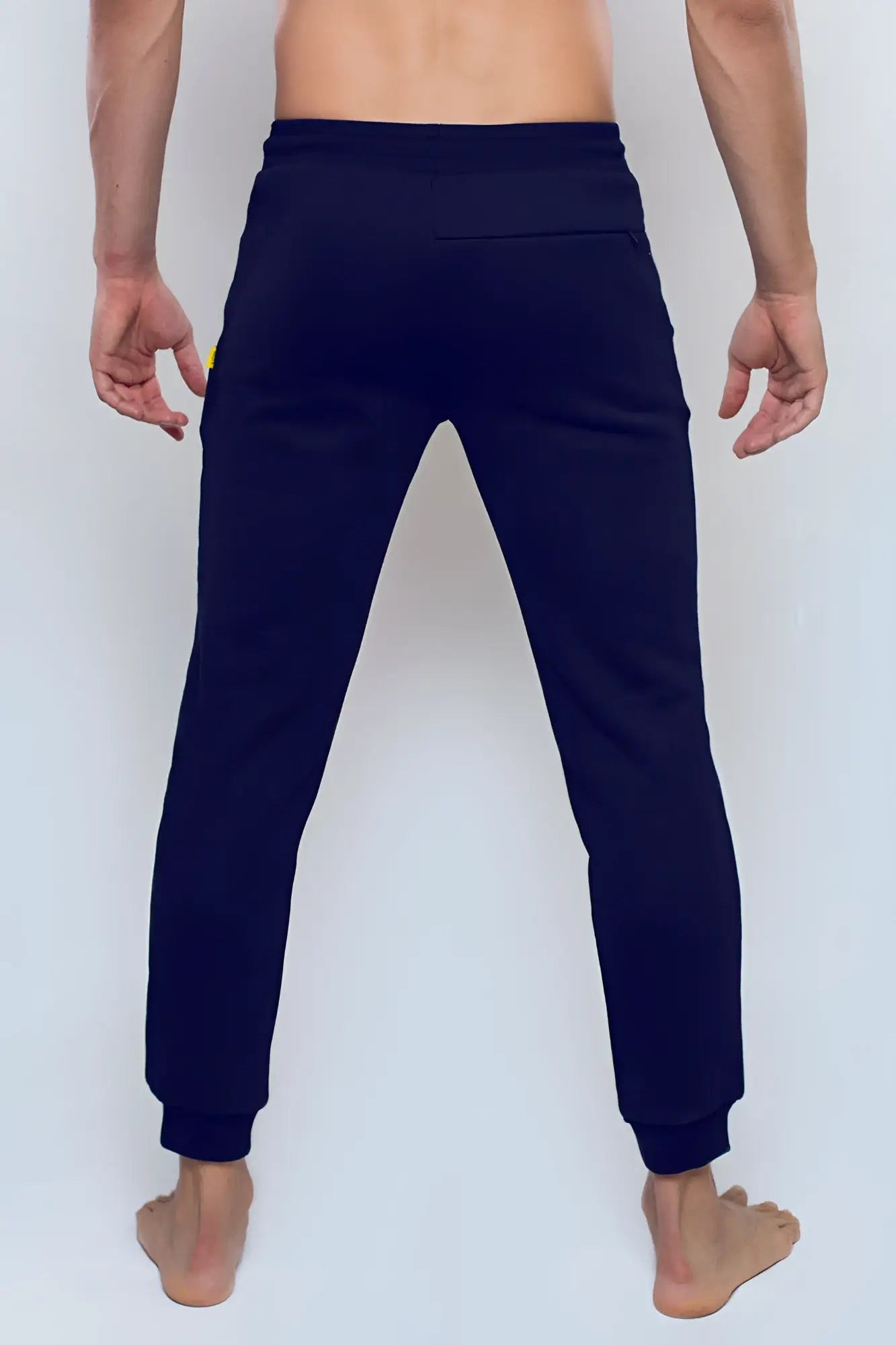 Navy blue supawear recovery jogger pants with subtle yellow logo on left thigh designed for comfort and performance