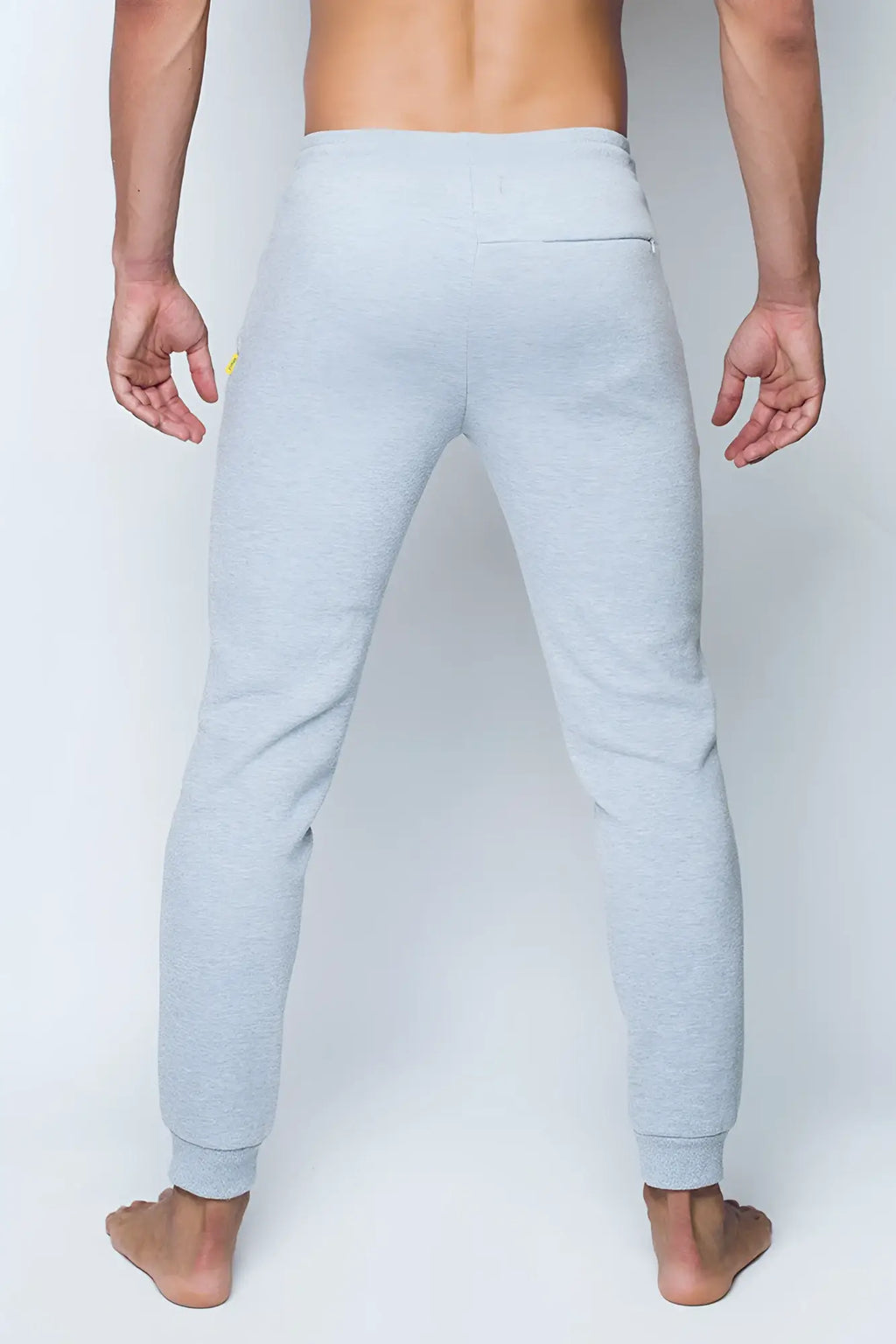 Light gray heathered supawear recovery jogger pants with subtle yellow logo on the left thigh