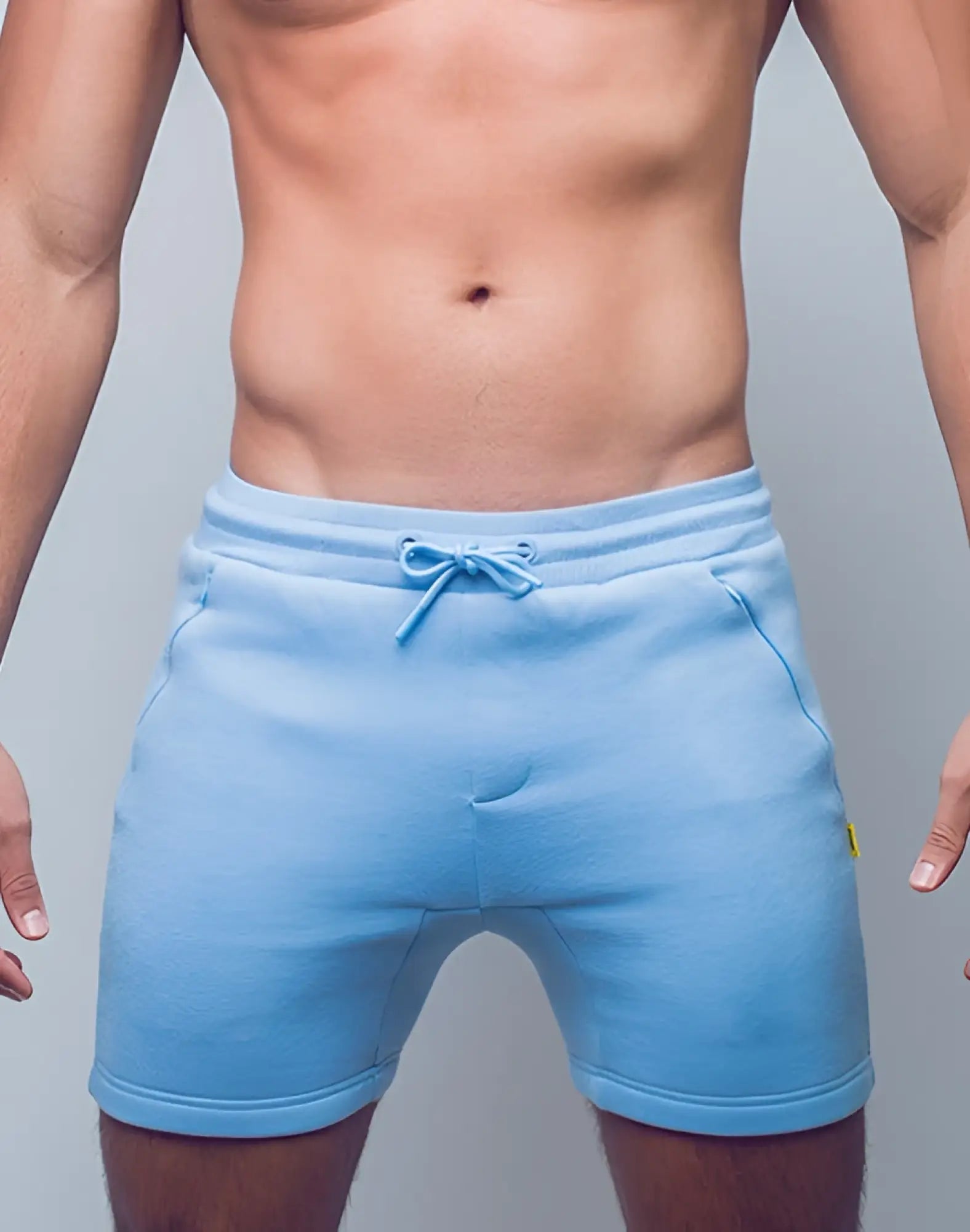 Light blue SUPAWEAR Recovery Shorts made of fleece with matching drawstring waistband and side pockets