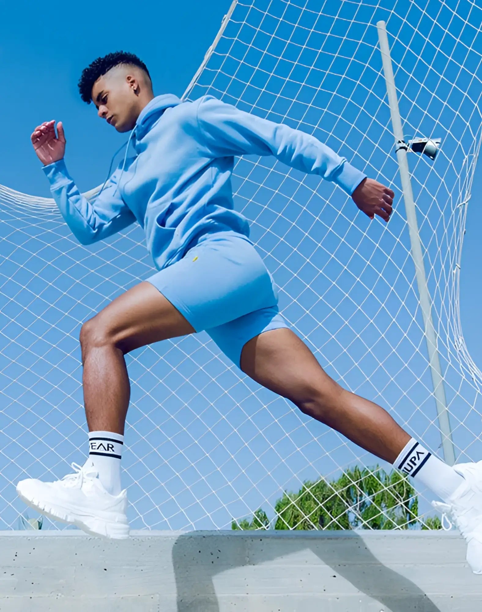 Light blue supra hoodie and matching recovery shorts set in soft fabric for comfortable post-workout wear