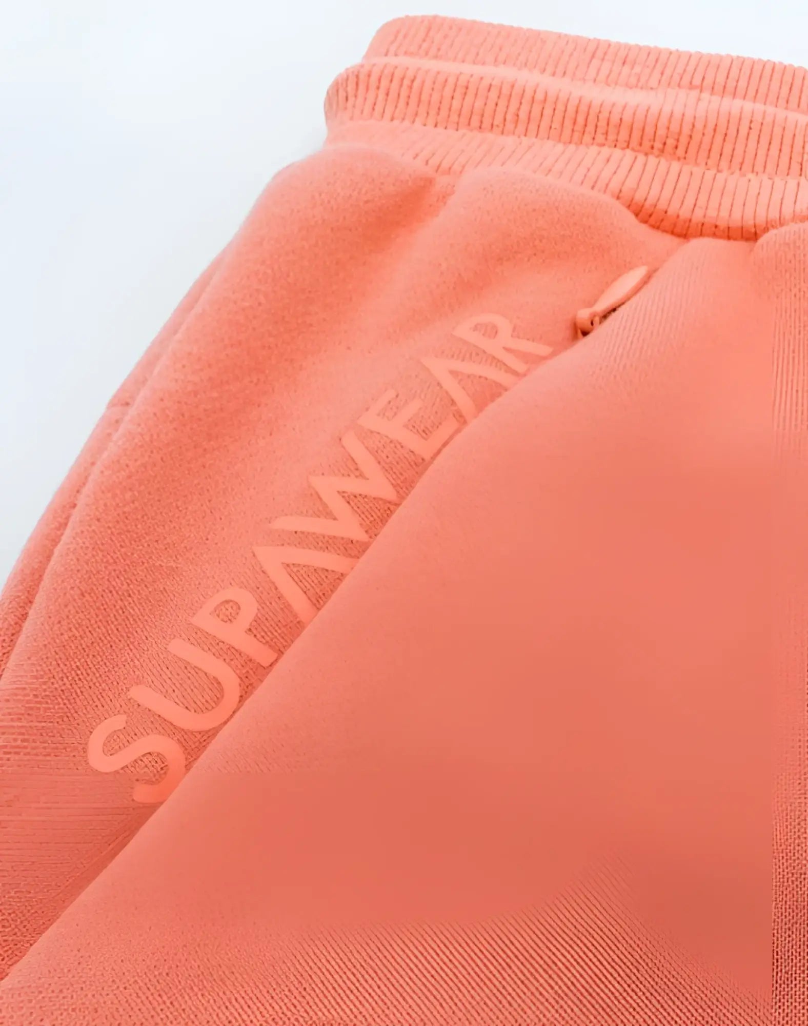 Coral supawear recovery shorts with ribbed waistband and subtle brand lettering in reboot clay color