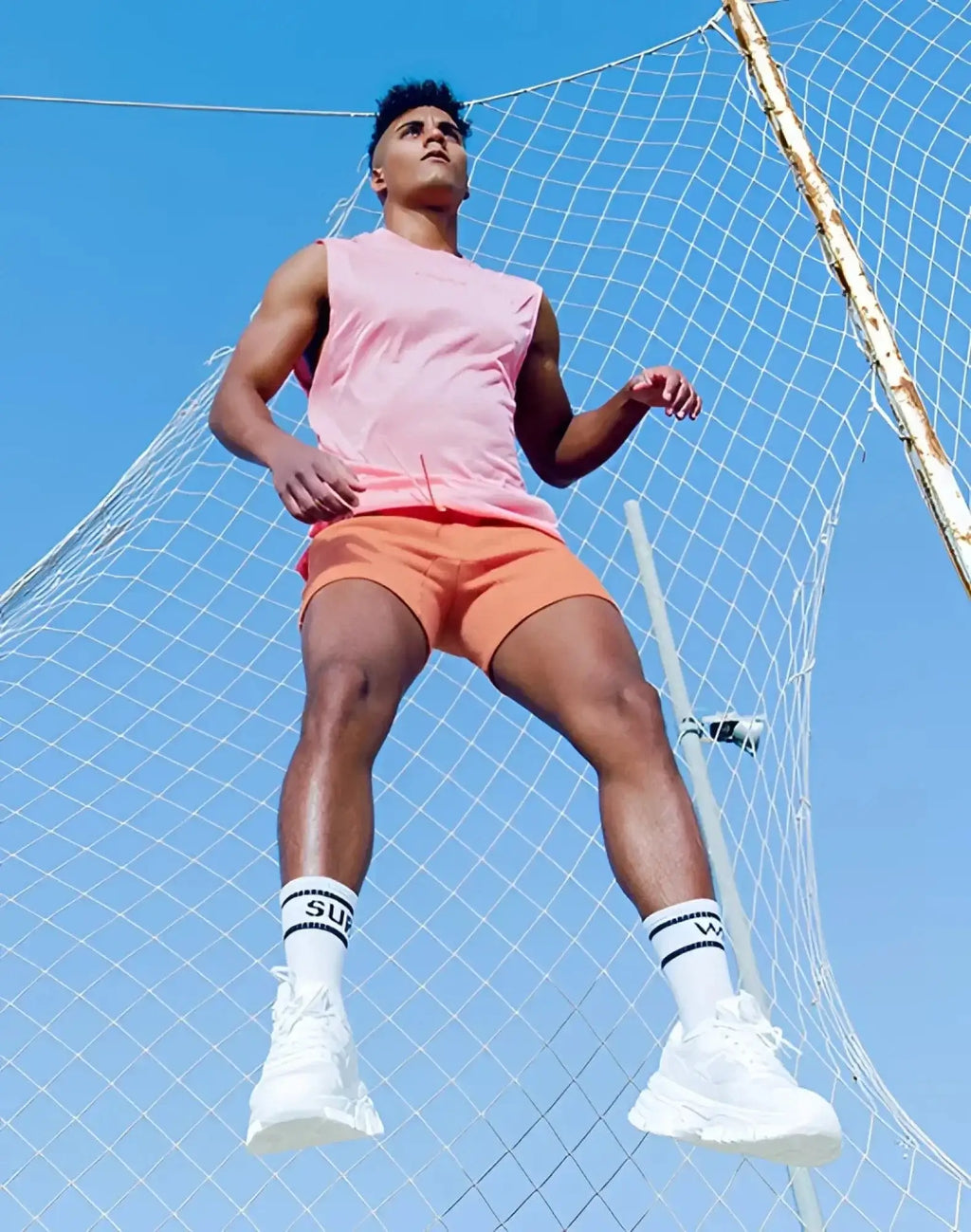 White athletic sneakers with chunky sole and breathable mesh upper shown with supawear recovery shorts reboot clay
