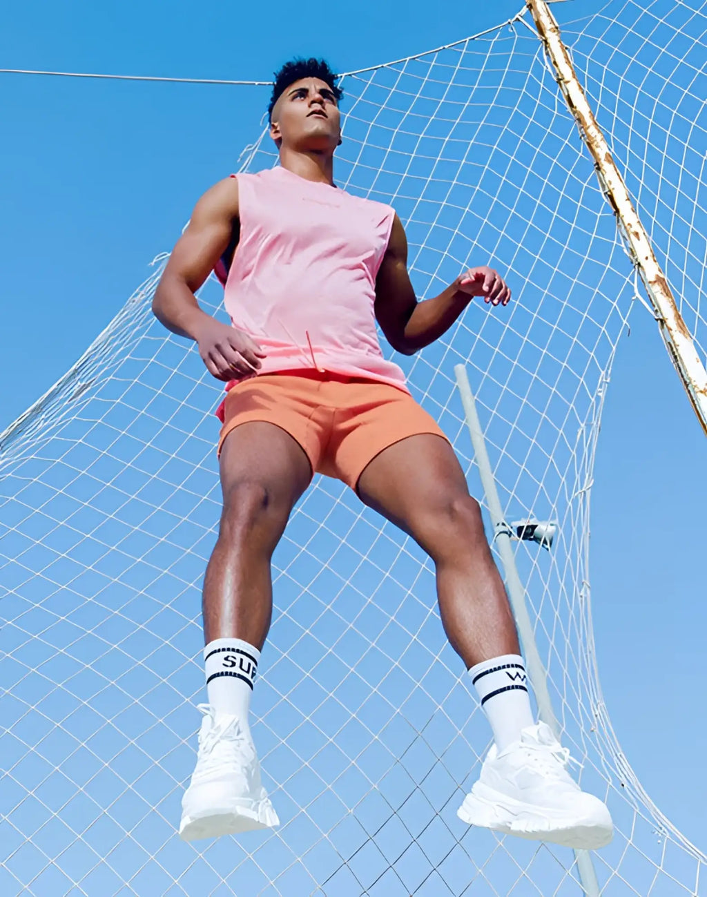 White athletic sneakers with chunky sole and breathable mesh upper shown with supawear recovery shorts reboot clay