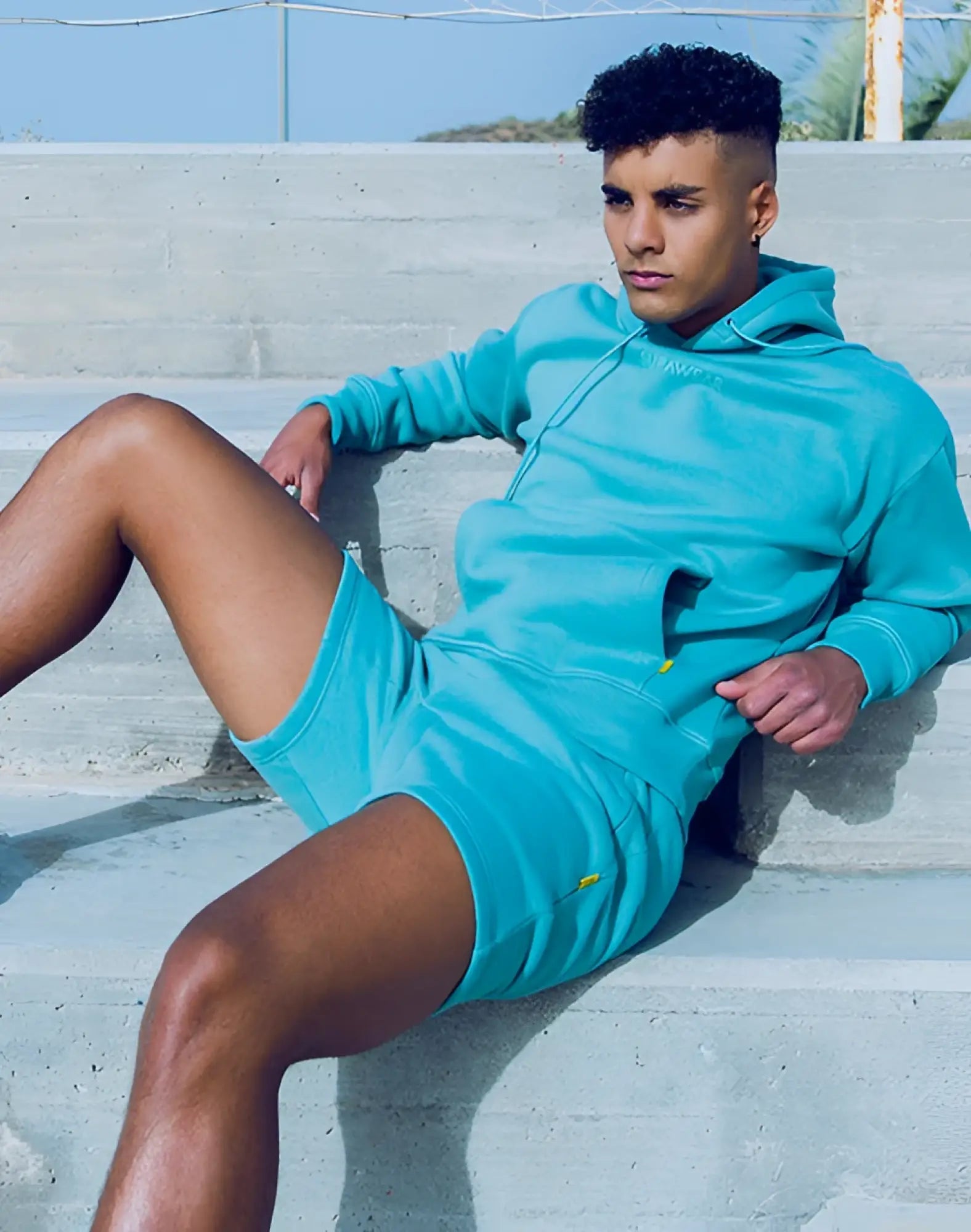 Turquoise supawear recovery two-piece hoodie and shorts set with yellow accents for active wear and comfort