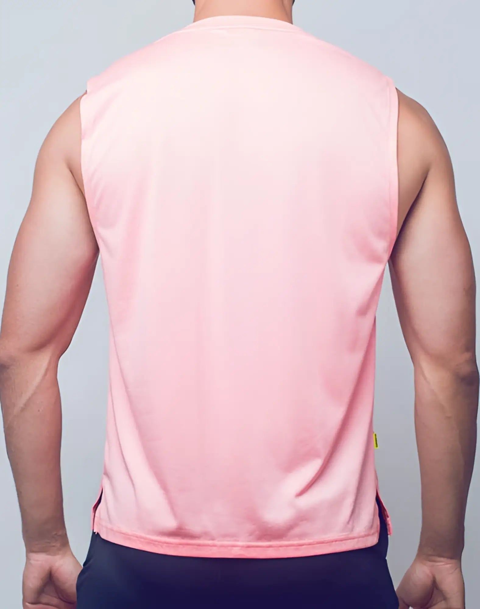 A pink sleeveless SUPAWEAR recovery tank made of smooth lightweight fabric with subtle side seams in reboot clay color