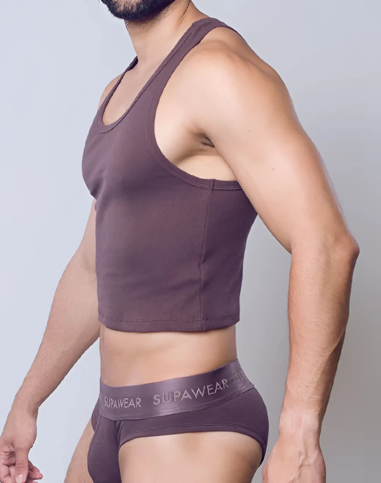 A mauve SUPAWEAR ribbed cropped singlet with racerback design paired with matching underwear featuring the brand name