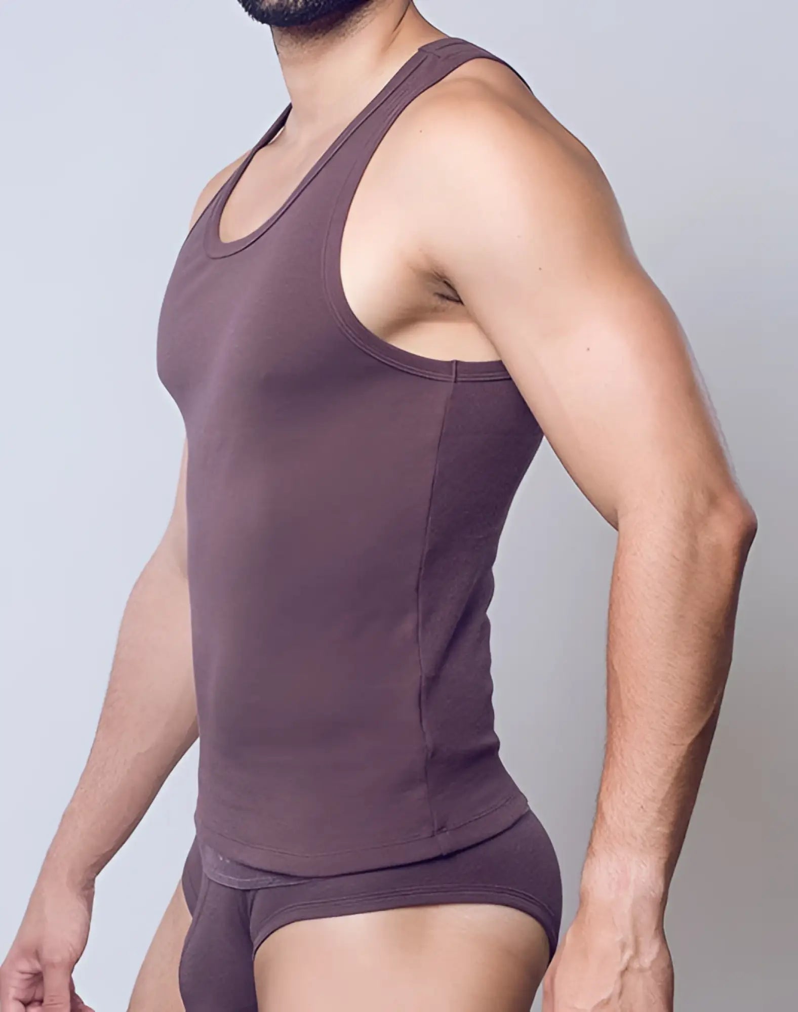 A fitted dark brown ribbed cotton tank top with a rounded neckline and seamless seams from SUPAWEAR Peppercorn