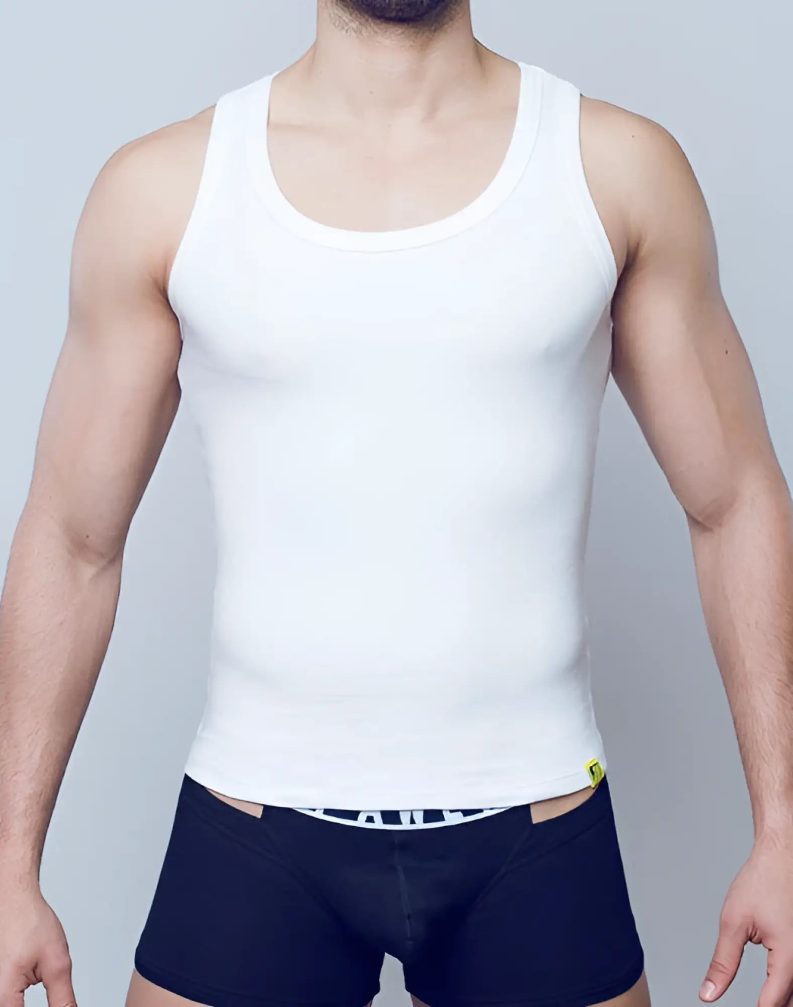 White SUPAWEAR ribbed singlet tank top with rounded neckline and elastic waistband for casual wear