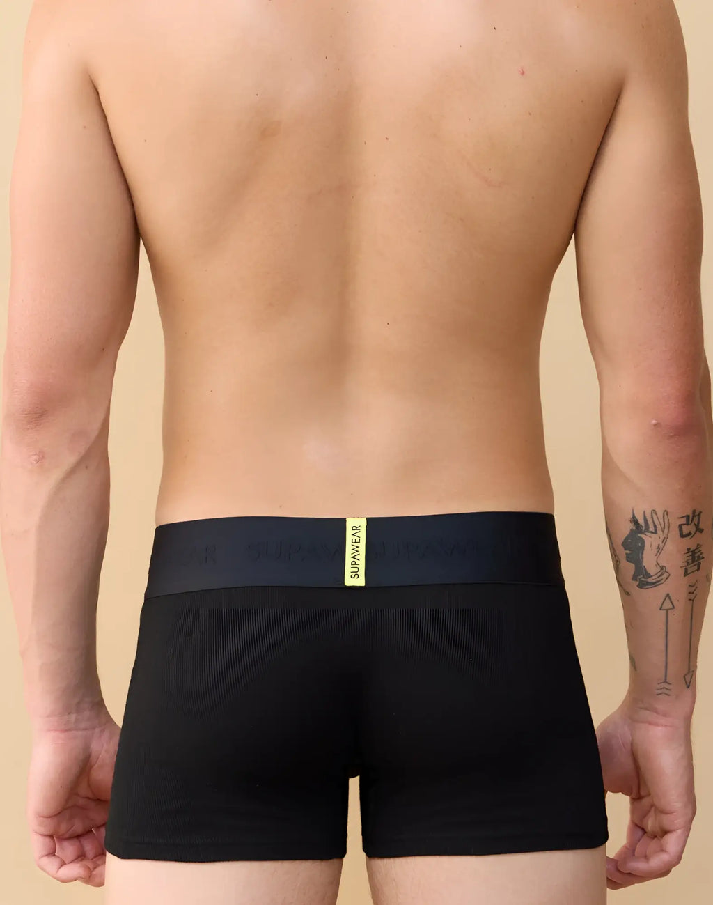 Black supima cotton SUPAWEAR ribbed trunk briefs with a navy waistband and yellow brand logo