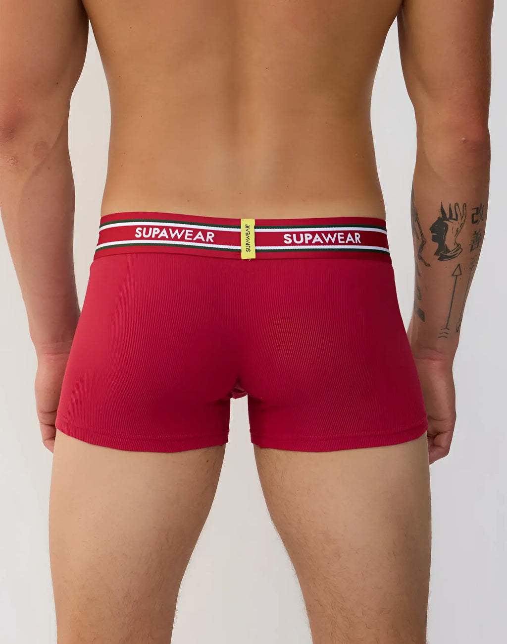 Red ribbed supawear boxer briefs with a striped waistband featuring the brand name in white lettering