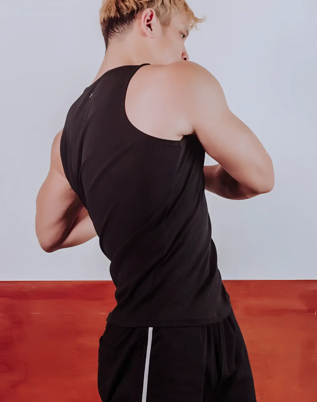 Black SUPAWEAR semi-squared singlet with a simple fitted design, perfect for athletic performance and workouts