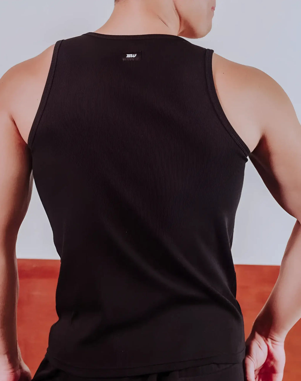 Black SUPAWEAR semi-squared singlet ribbed tank top with small white logo at the neckline