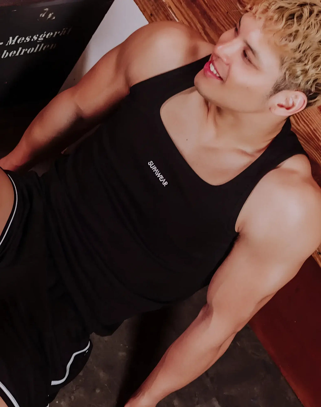 Black survivor tank top with white lettering in a fitted design by SUPAWEAR semi-squared singlet