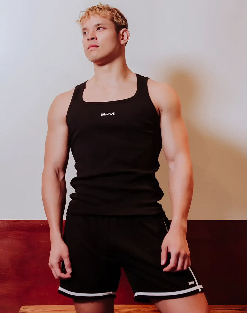 Black SUPAWEAR semi-squared singlet tank top with white sunwear logo on chest made from breathable fabric