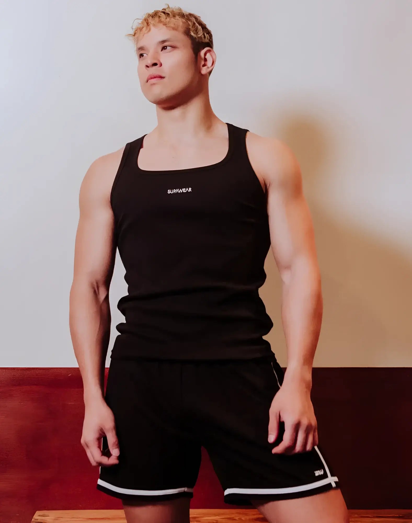 Black SUPAWEAR semi-squared singlet tank top with white sunwear logo on chest made from breathable fabric