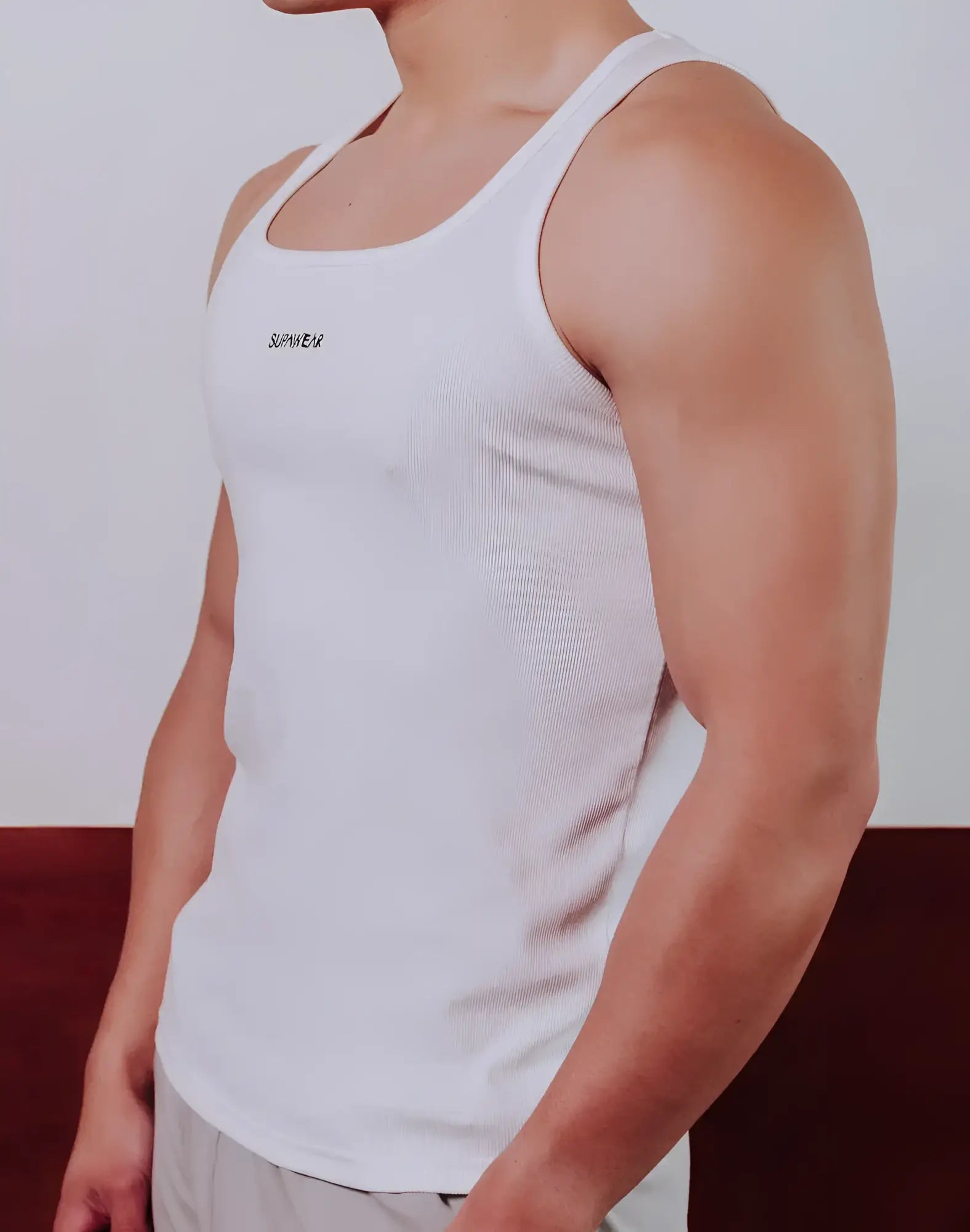 White ribbed cotton SUPAWEAR semi-squared singlet with small black embroidered logo on the chest