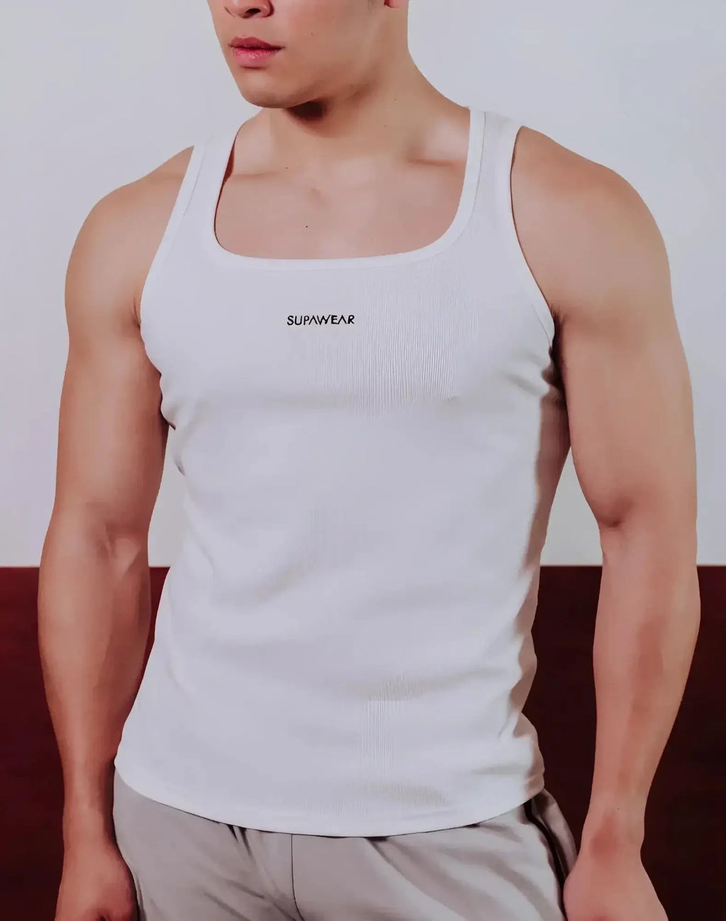 White ribbed SUPAWEAR semi-squared singlet with logo on chest made from lightweight fabric perfect for casual wear