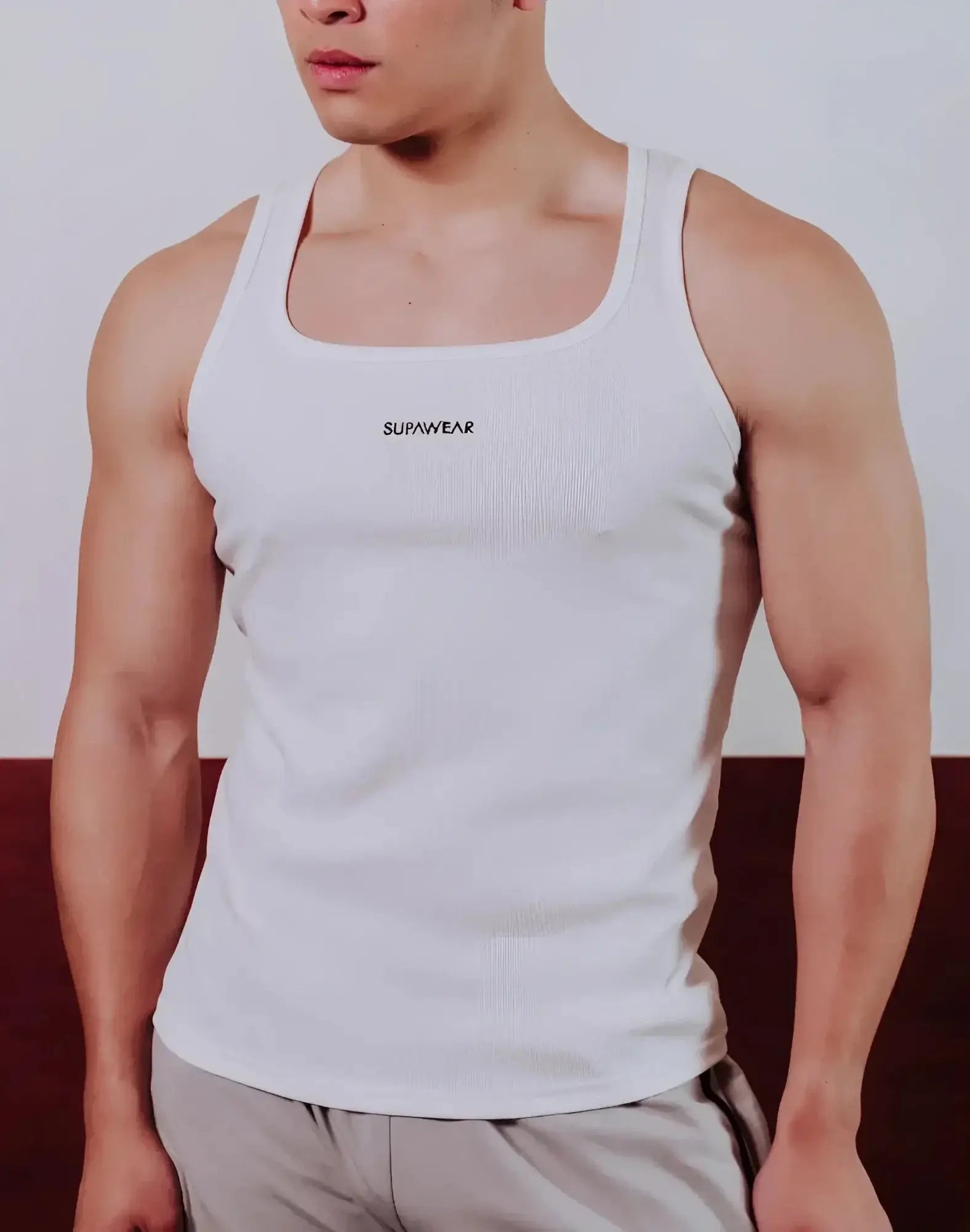 White ribbed SUPAWEAR semi-squared singlet with logo on chest made from lightweight fabric perfect for casual wear
