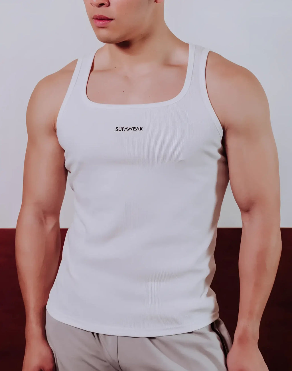 White ribbed SUPAWEAR semi-squared singlet with logo on chest made from lightweight fabric perfect for casual wear