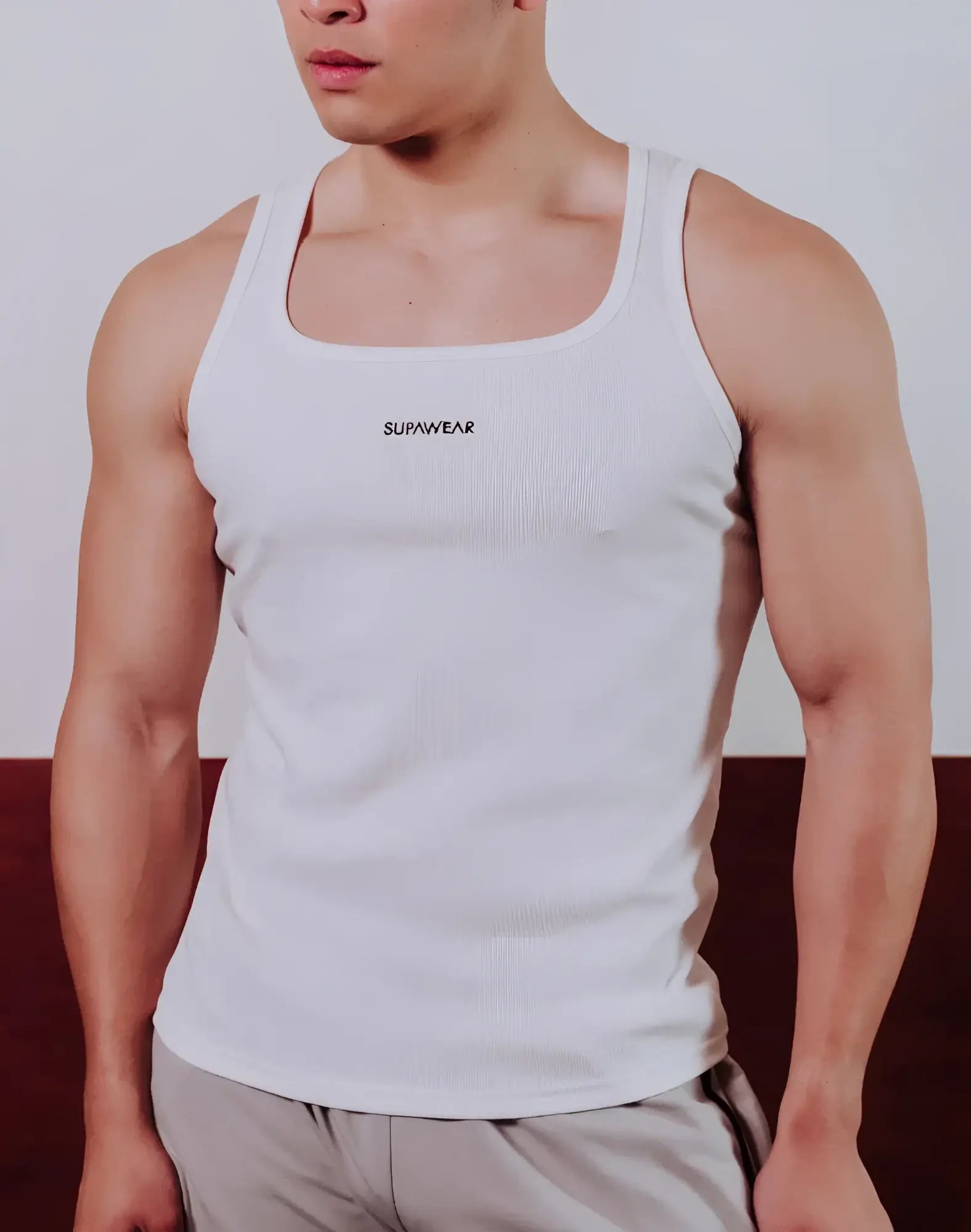White ribbed SUPAWEAR semi-squared singlet with logo on chest made from lightweight fabric perfect for casual wear