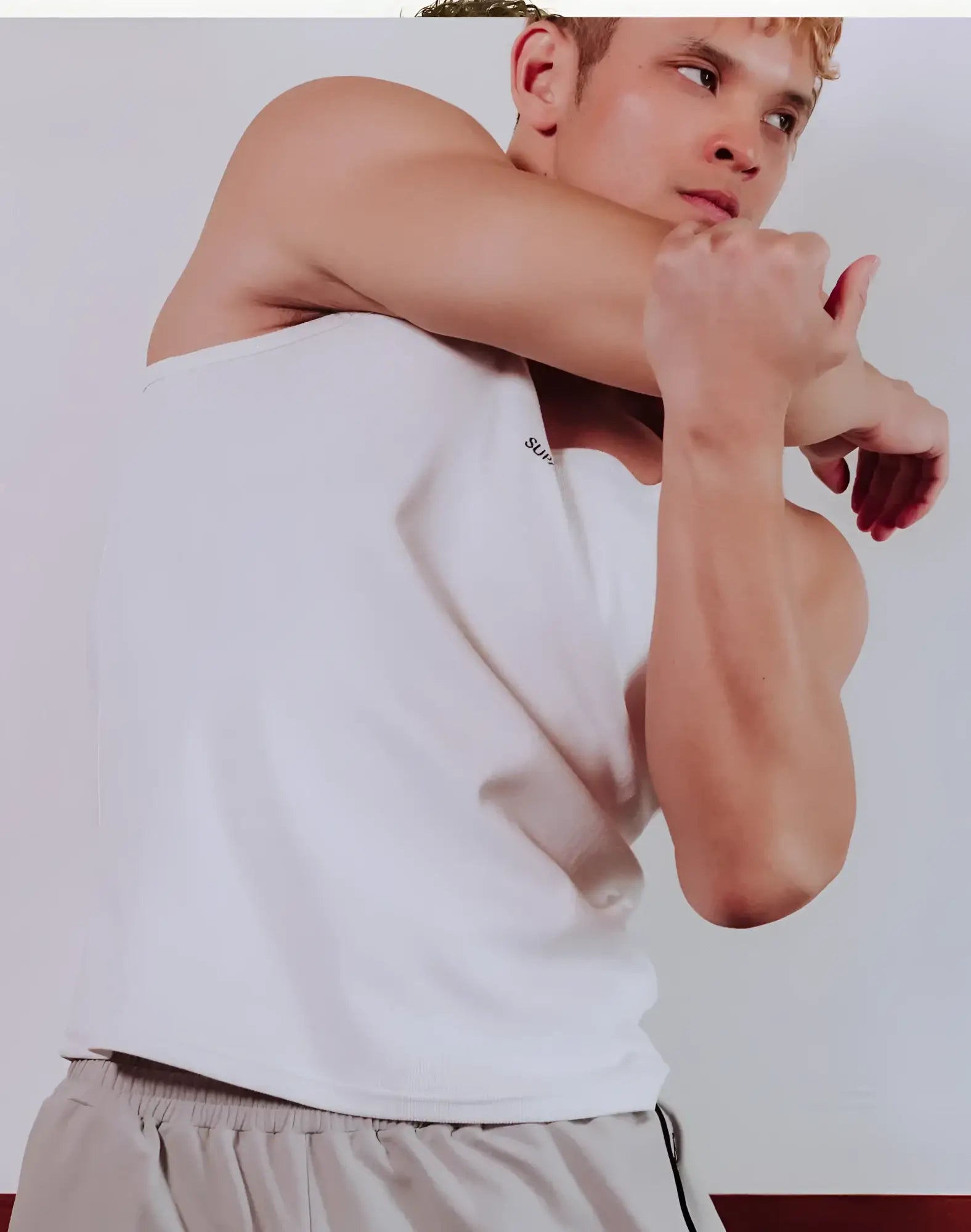 White sleeveless SUPAWEAR Semi-Squared Singlet with subtle left chest branding made from lightweight fabric