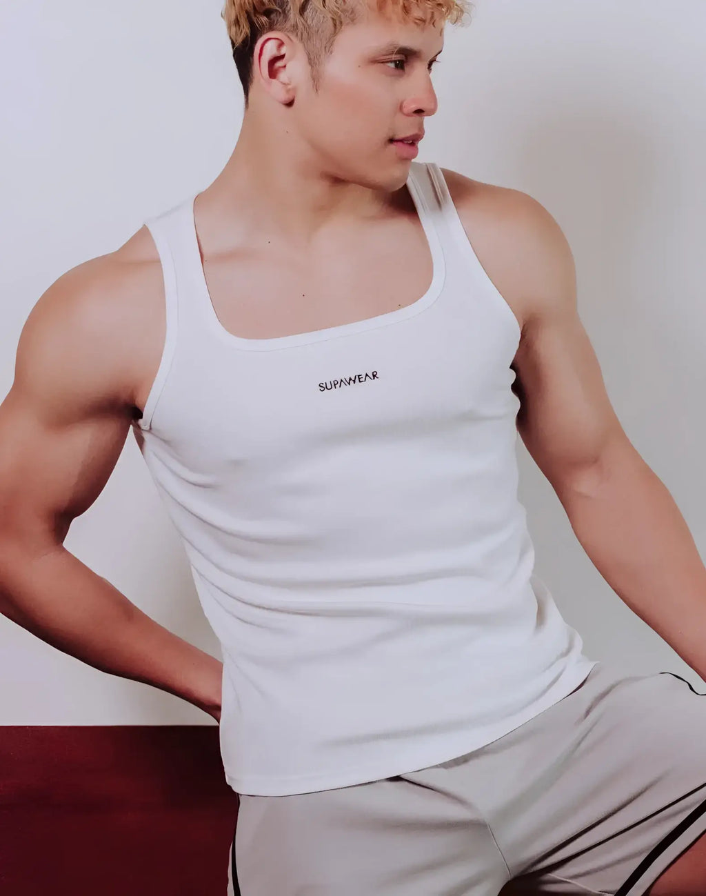 White supawear semi-squared singlet tank top with a fitted design and subtle black branding on the chest