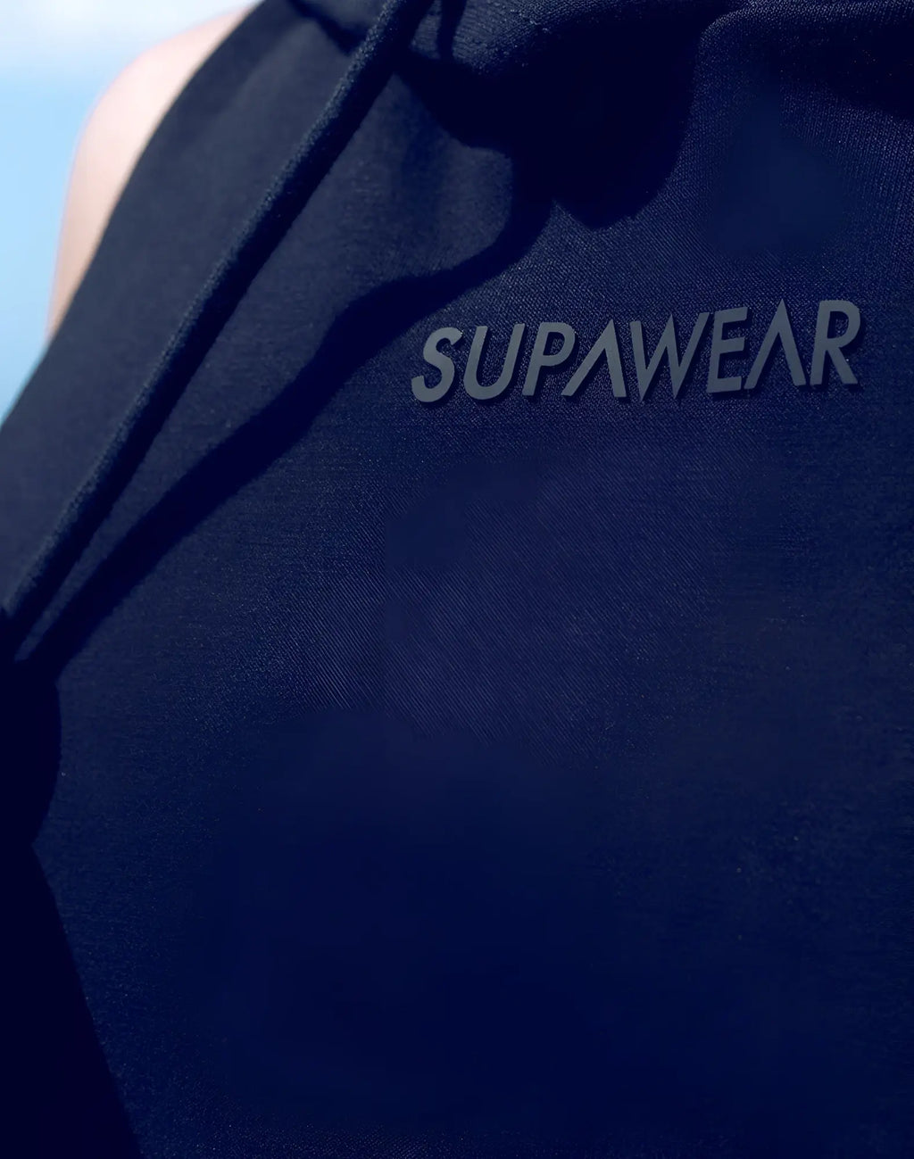 SupaWear sleeveless hoodie in dark navy blue with a subtle raised gray logo embroidered across the chest