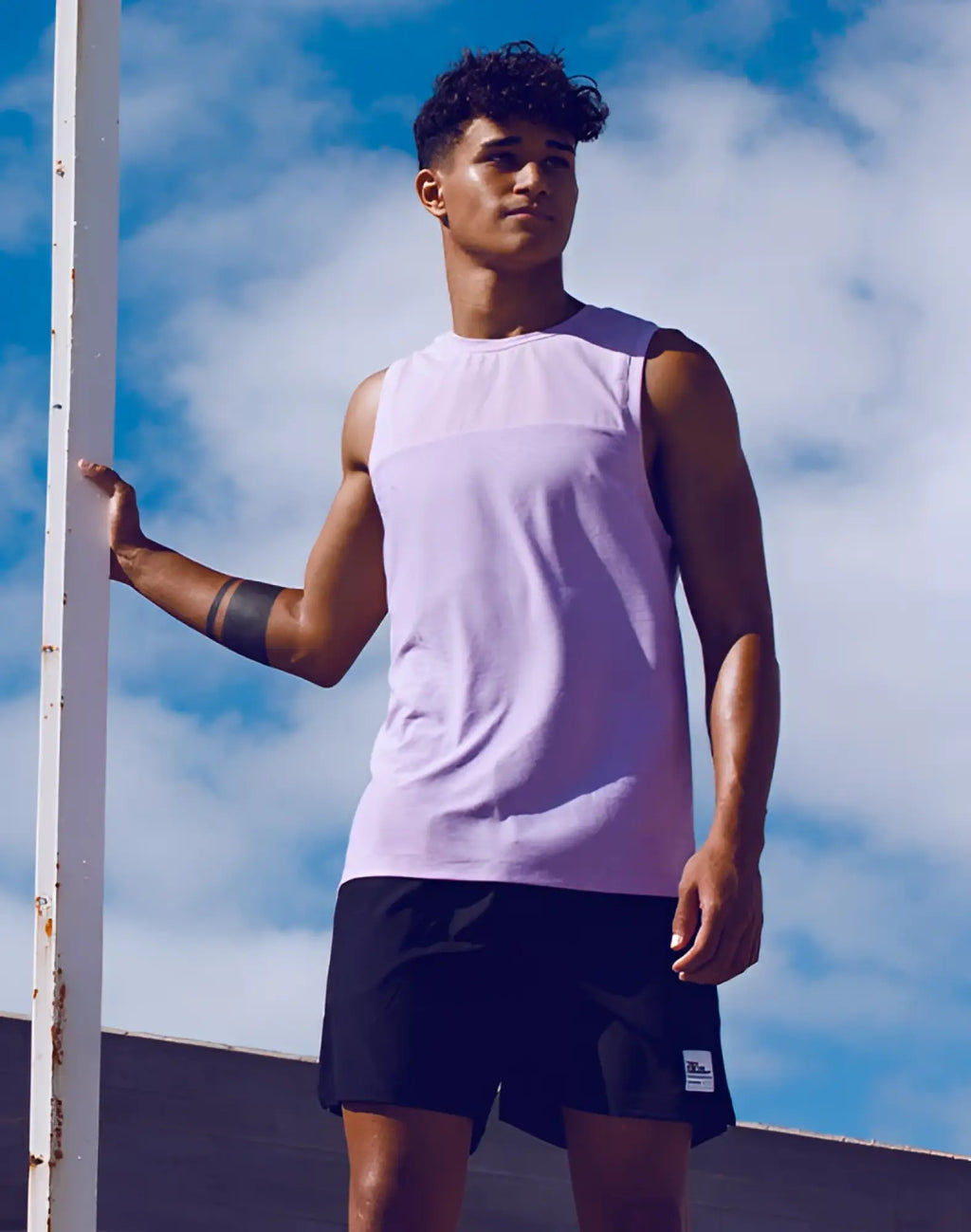 A light purple heather sleeveless fitted athletic tank top with solid and mesh fabric by supawear