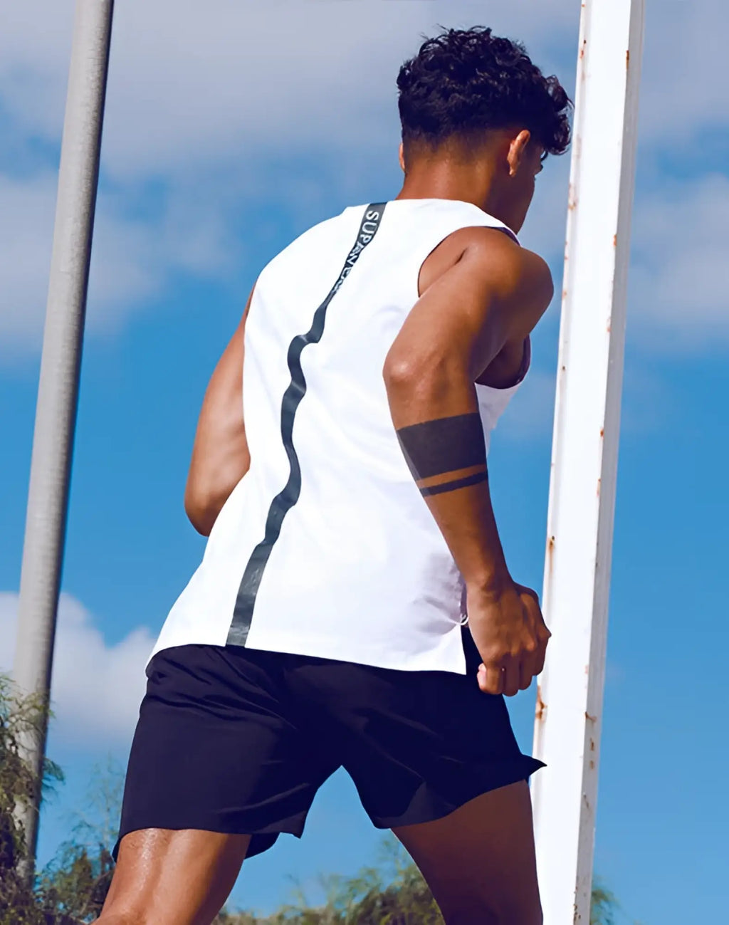 White sleeveless SUPAWEAR solid and mesh tanktop showing the back with a black vertical stripe design