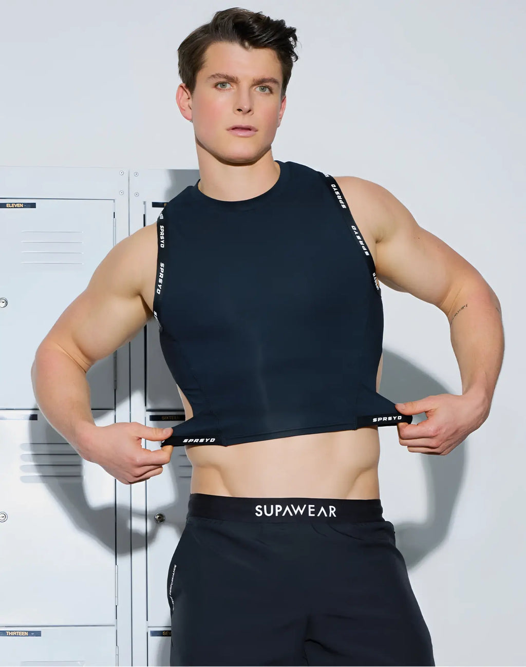 Black sleeveless SUPAWEAR SPR cropped tank with white spreto branding on straps and waistband for athletic use