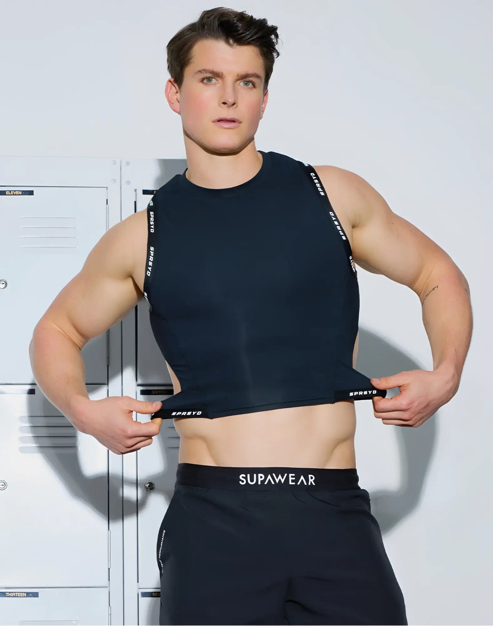 Black sleeveless SUPAWEAR SPR cropped tank with white spreto branding on straps and waistband for athletic use