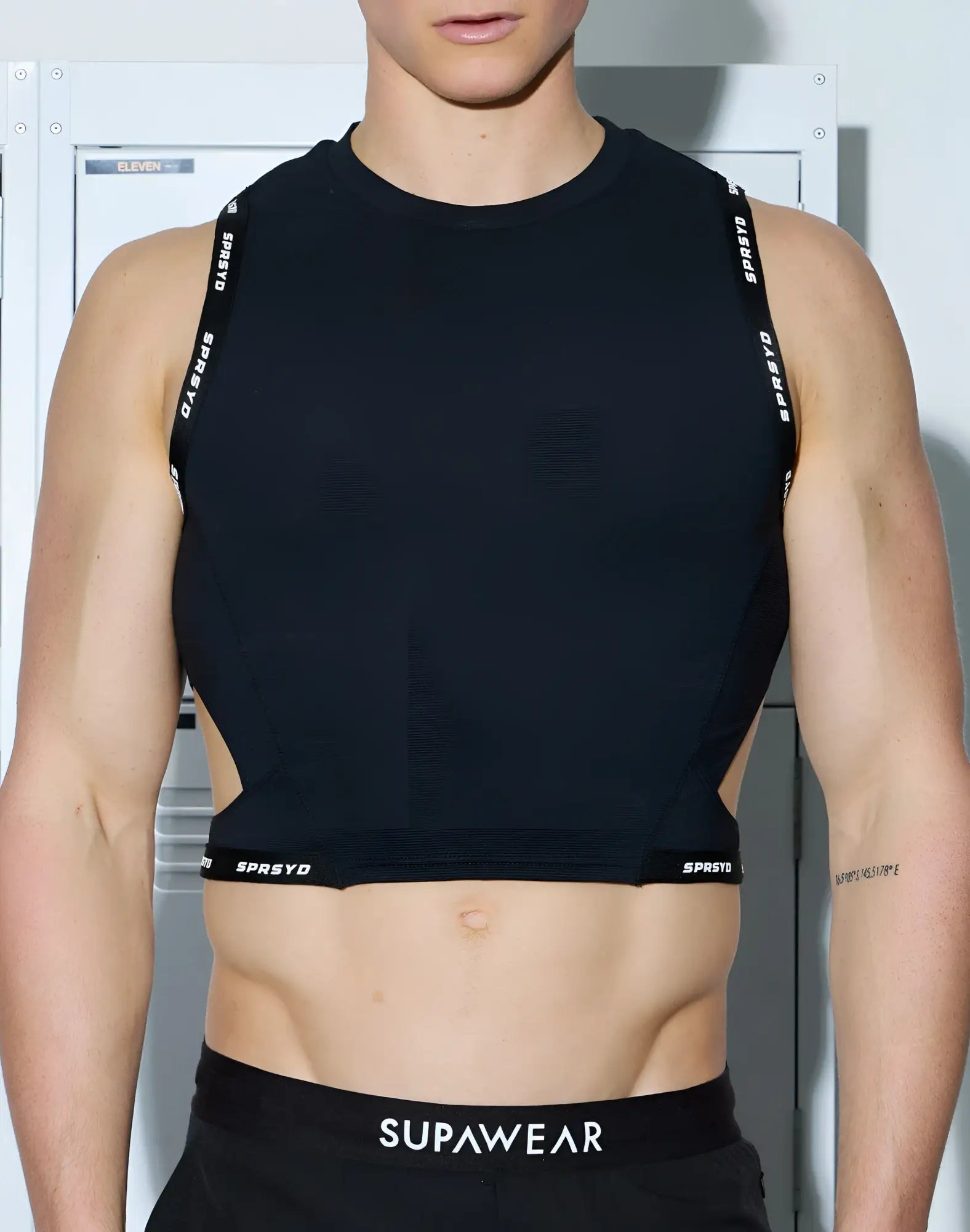 Black sleeveless SUPAWEAR SPR cropped tank with sprsyd branding on straps and hem made of stretchy athletic fabric
