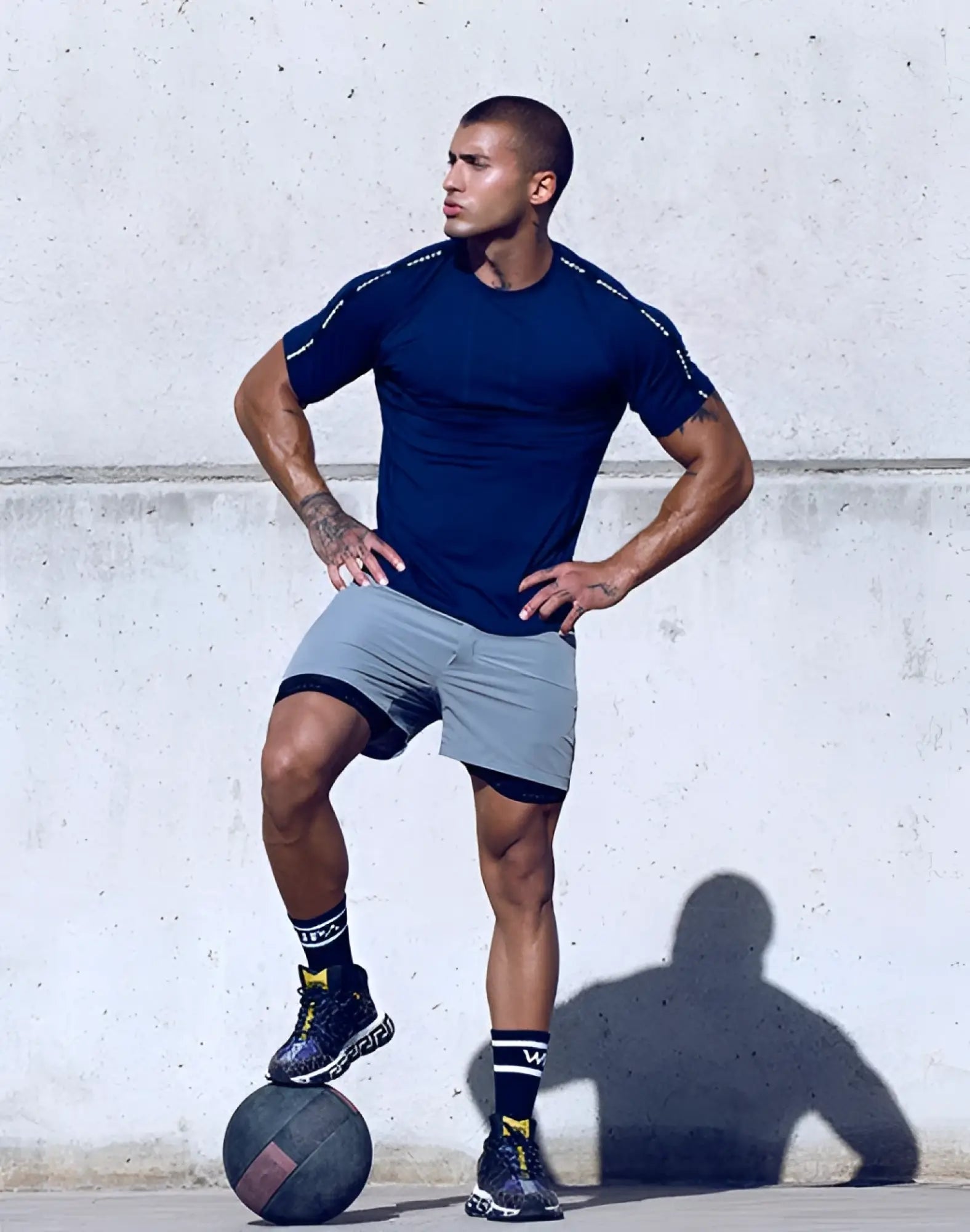 Navy blue SUPAWEAR SPR Fit athletic shirt with black trim and white sleeve lettering designed for active use