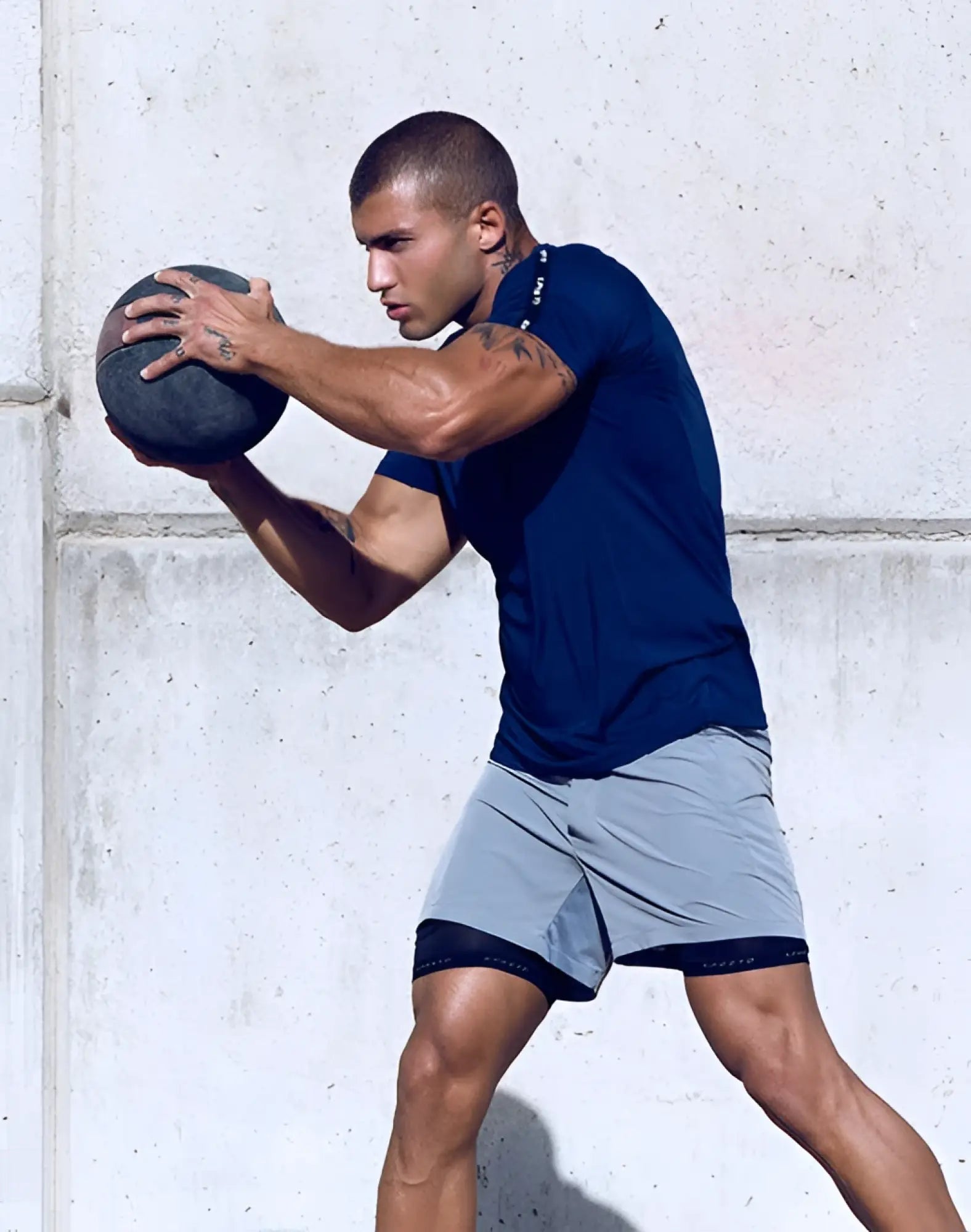 Dark blue SUPAWEAR SPR Fit tee with black trim on sleeves and hem designed for athletic performance