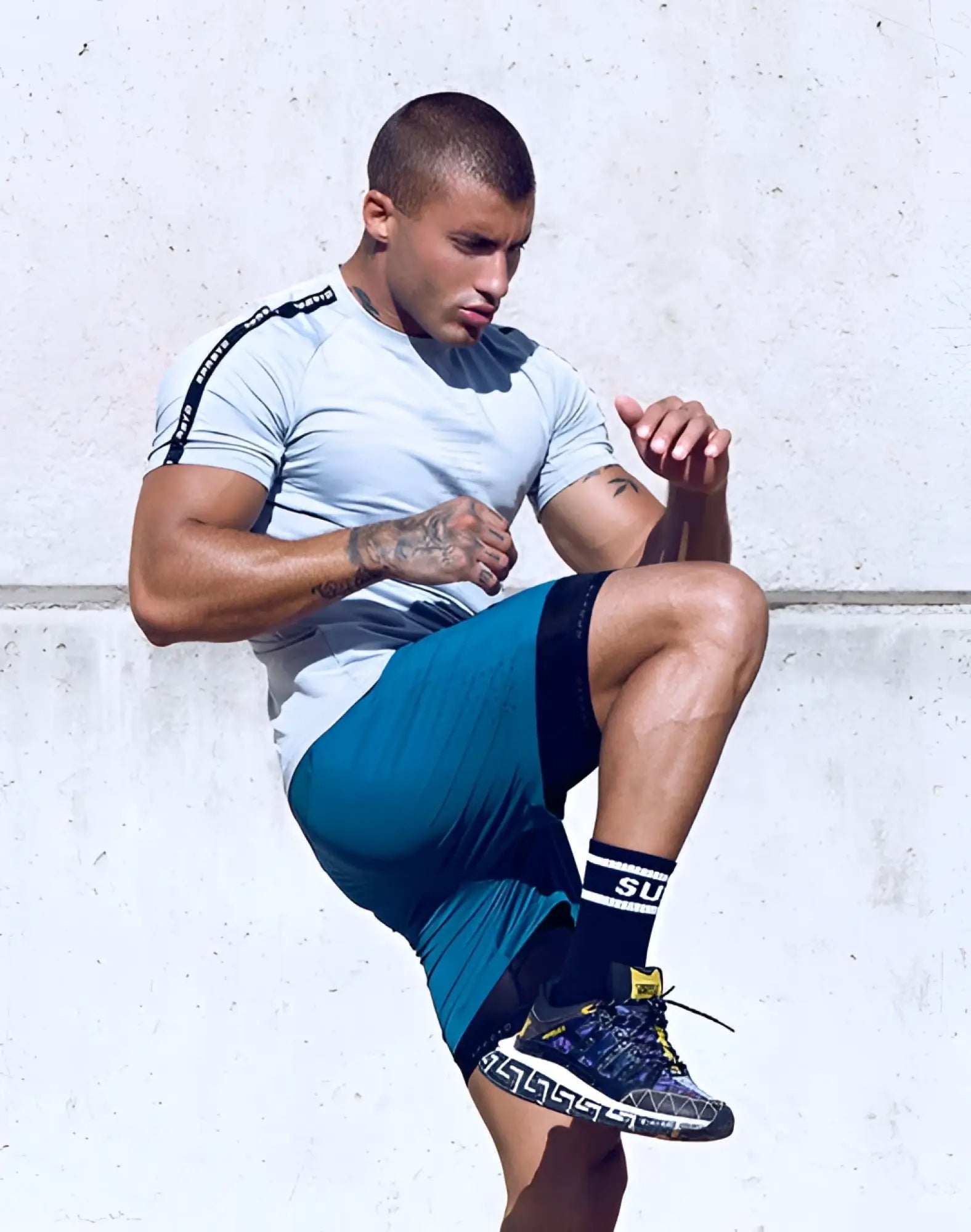 Blue and black athletic shoe with geometric pattern paired with supawear spr fit tee in pale grey for active wear