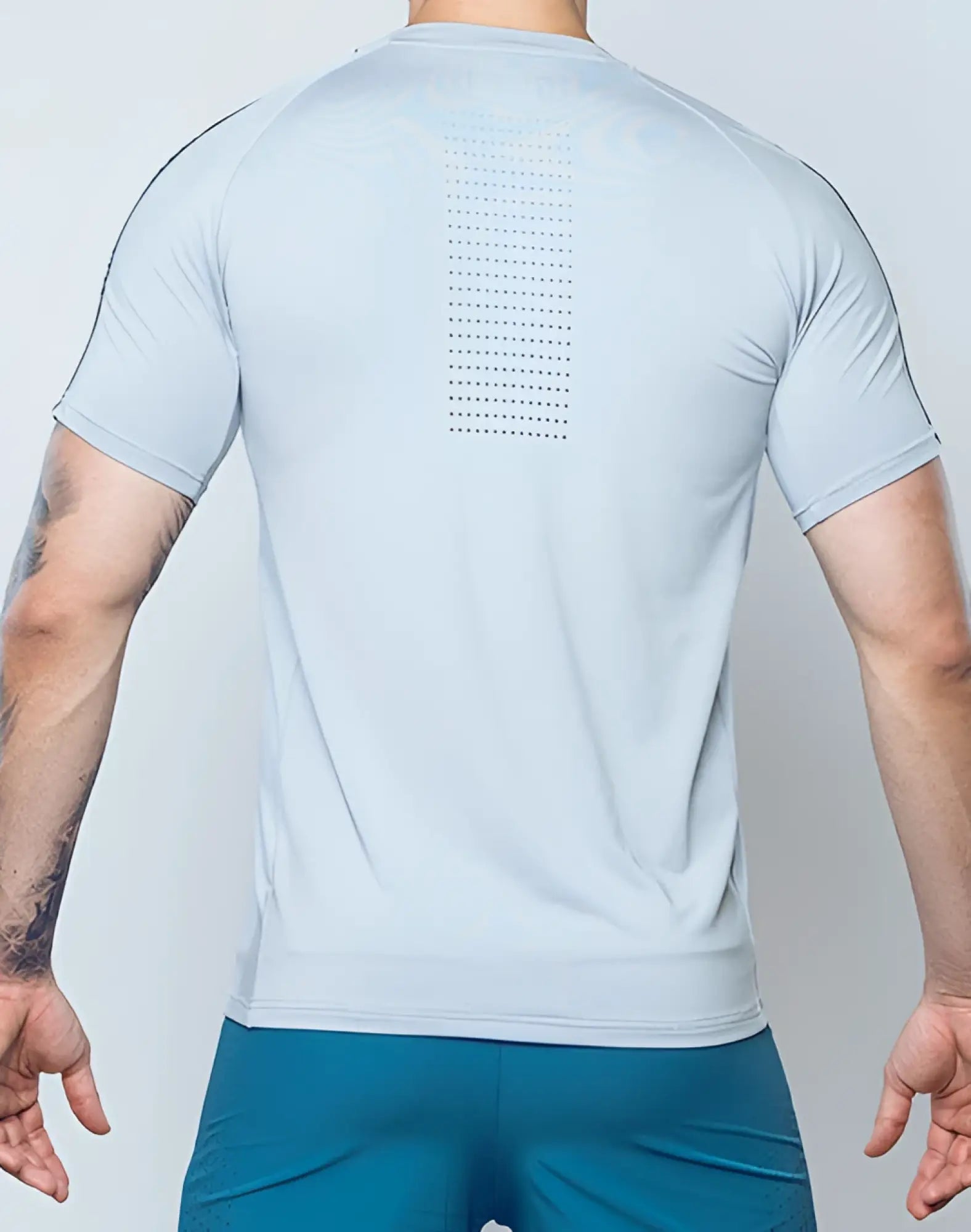 Back view of supawear SPR fit tee pale grey light blue short-sleeved athletic shirt with perforated vertical panel