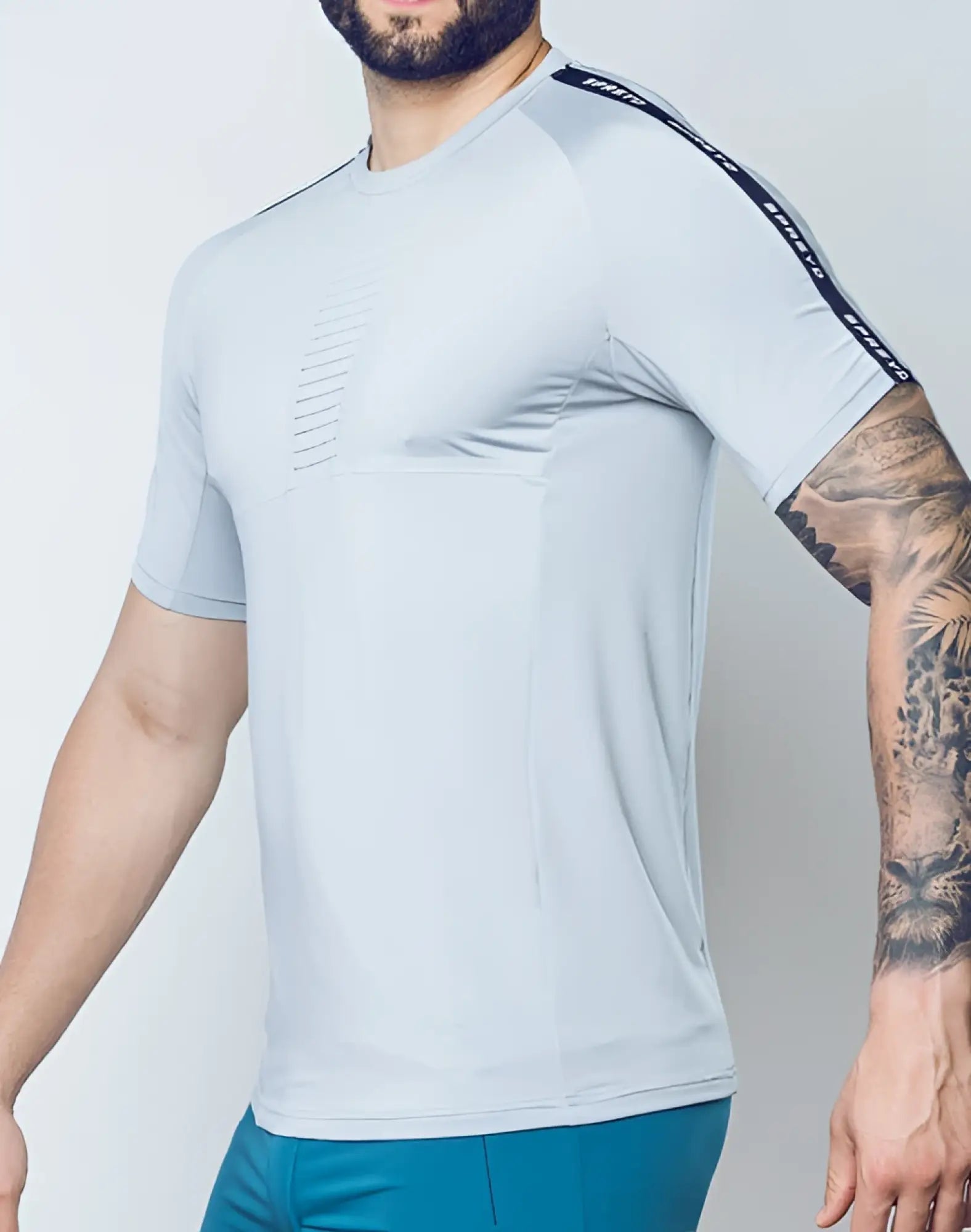 Light gray supawear spr fit tee with black text strip on sleeve and subtle perforated chest detailing