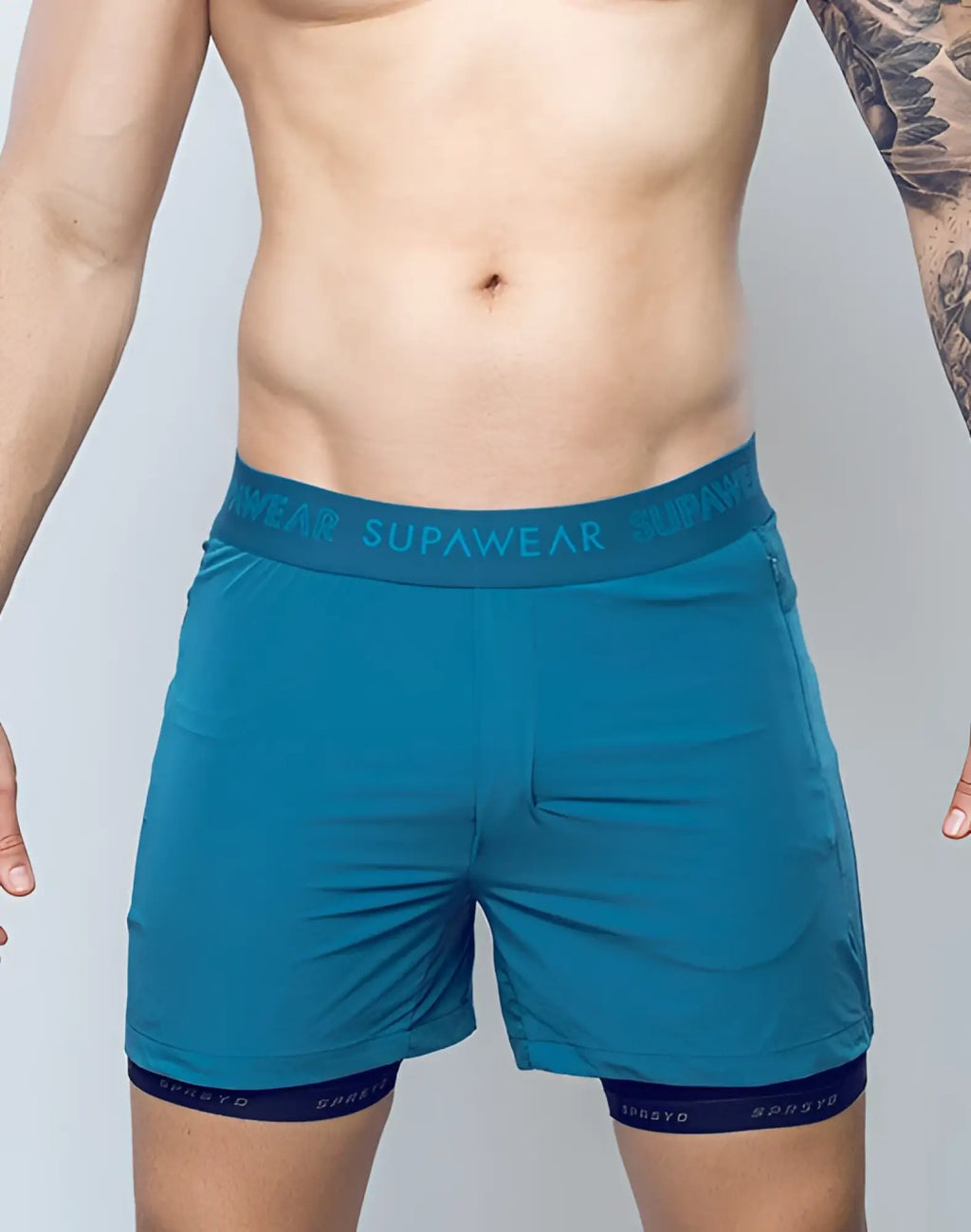 Supawear spr flex shorts in coral blue with teal elastic waistband and dark blue inner lining for athletic use