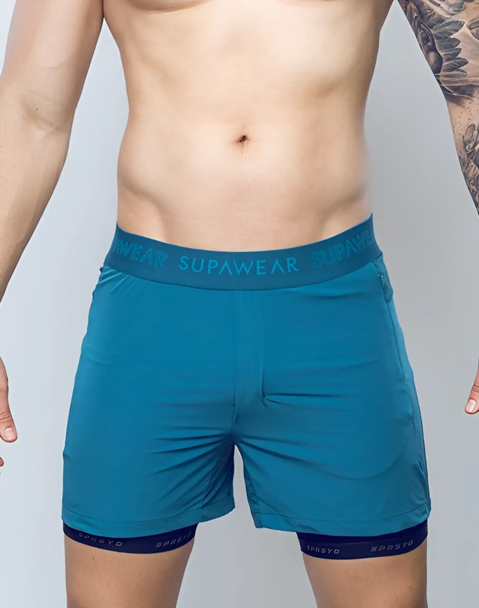 Supawear spr flex shorts in coral blue with teal elastic waistband and dark blue inner lining for athletic use