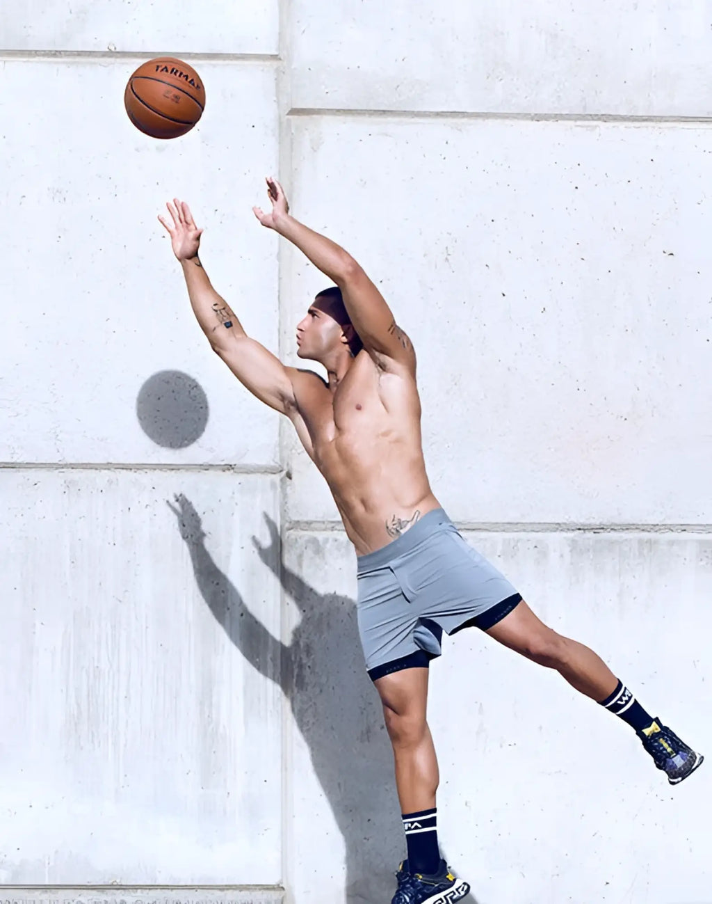 Orange leather basketball with larma branding shown alongside supawear spr flex shorts in titanium grey