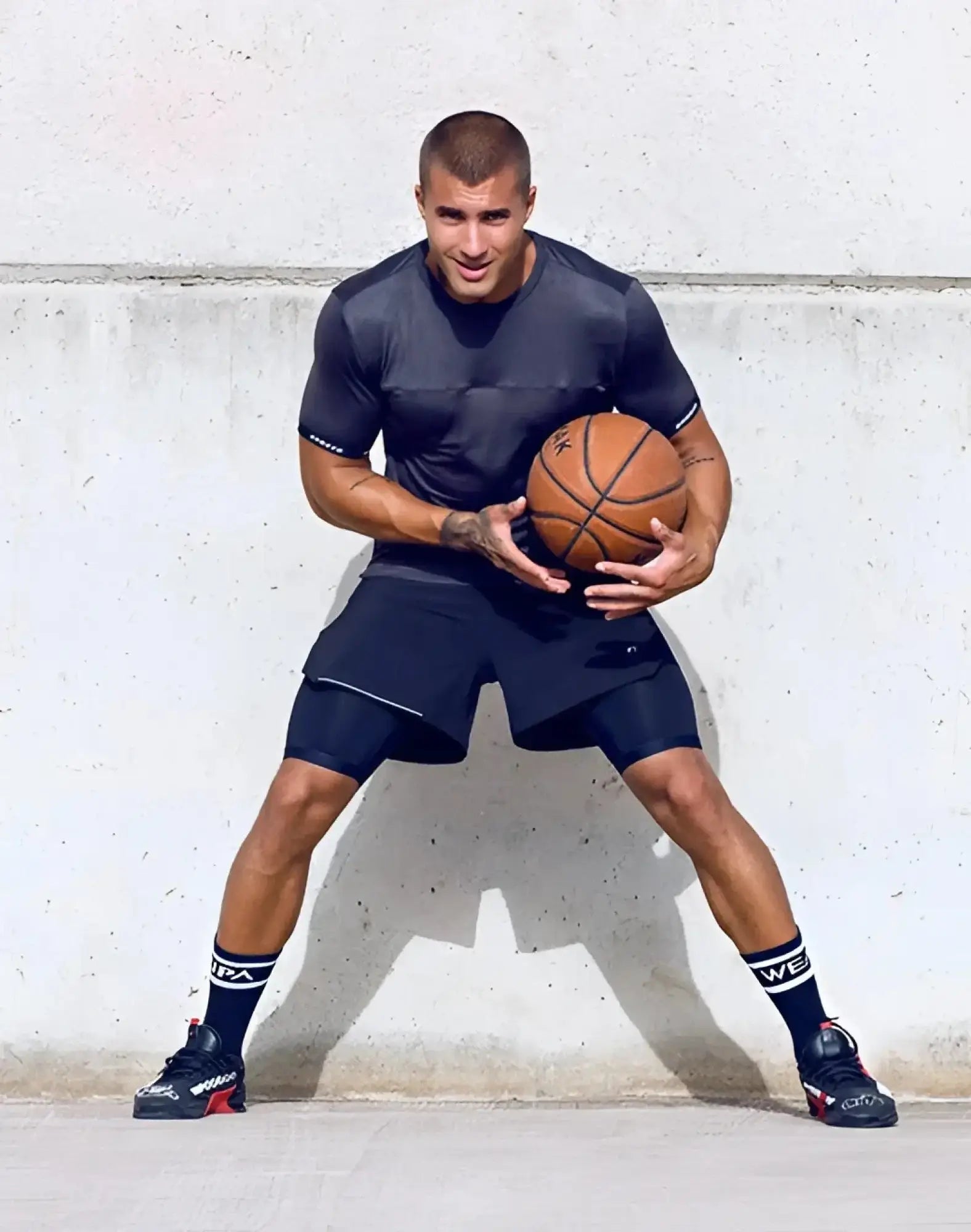 Orange leather basketball with black seams paired with supawear spr flex tee black for athletic performance