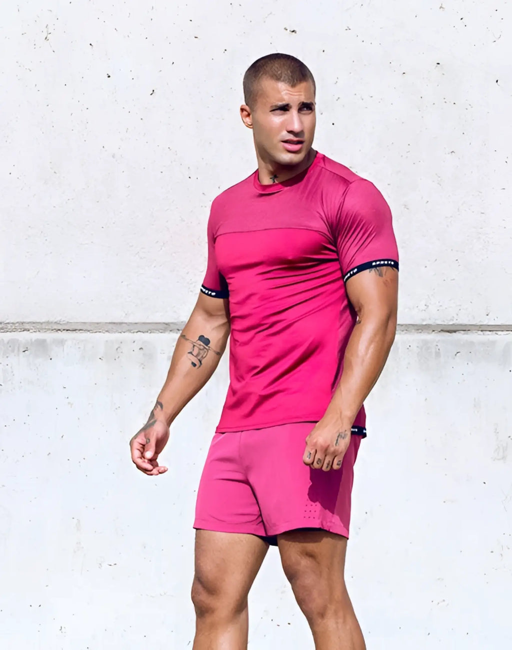A vibrant pink supawear spr flex tee short sleeve top with black trim and subtle textured pattern