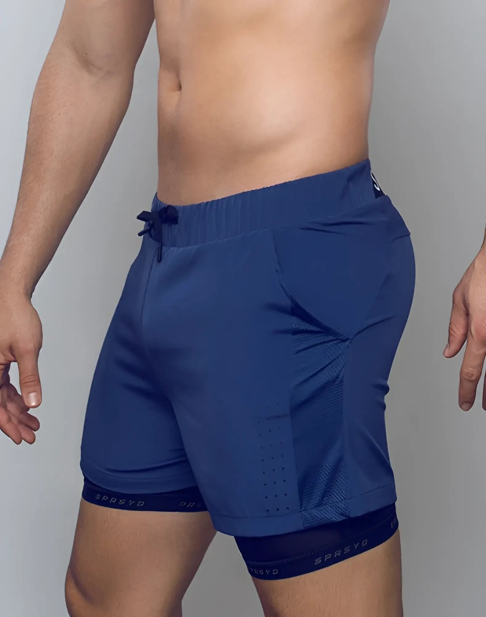 Navy blue SUPAWEAR SPR Max shorts with mesh paneling and drawstring waistband designed for athletic use