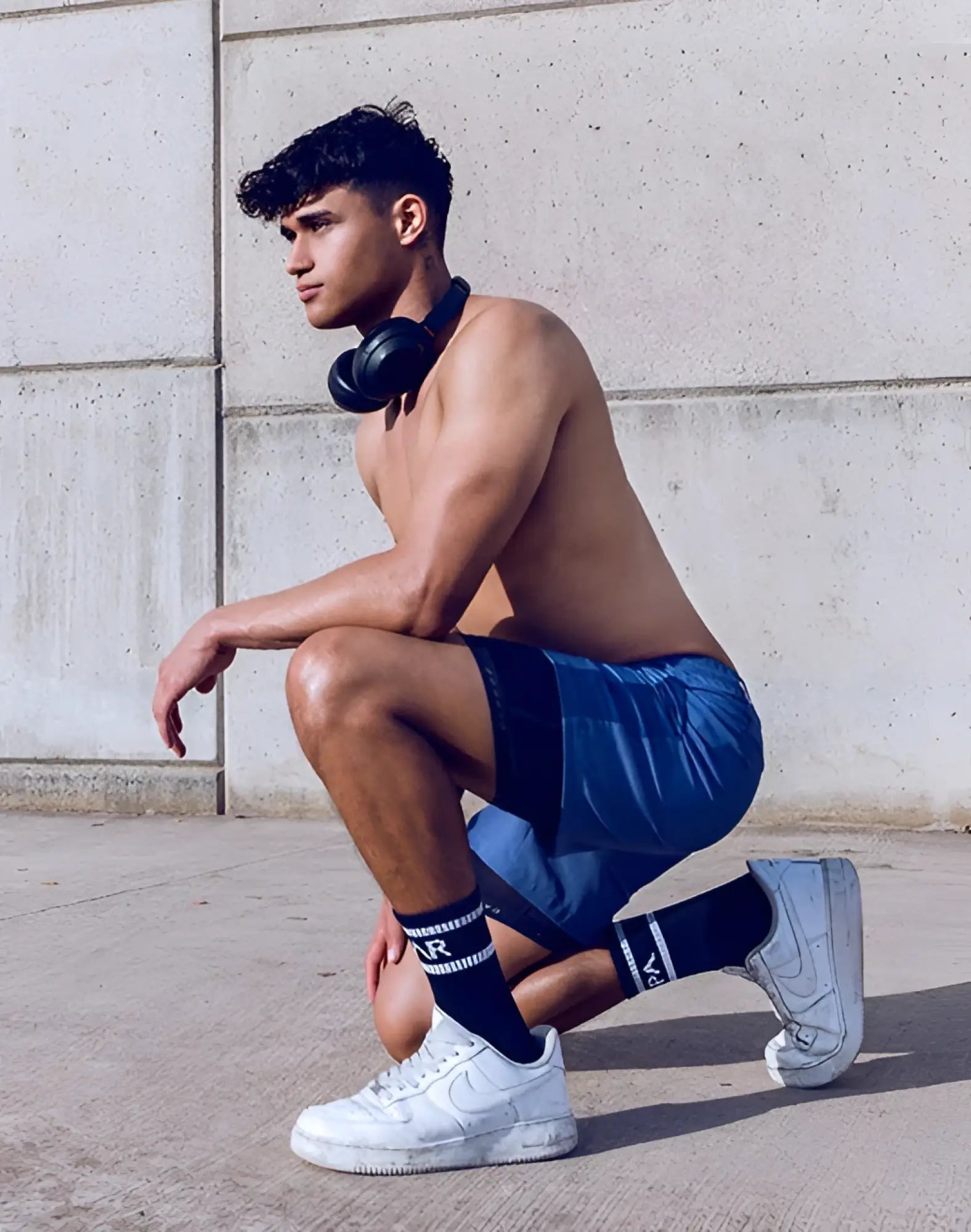 Black over-ear headphones with sleek modern design paired with supawear SPR Max shorts in navy blue