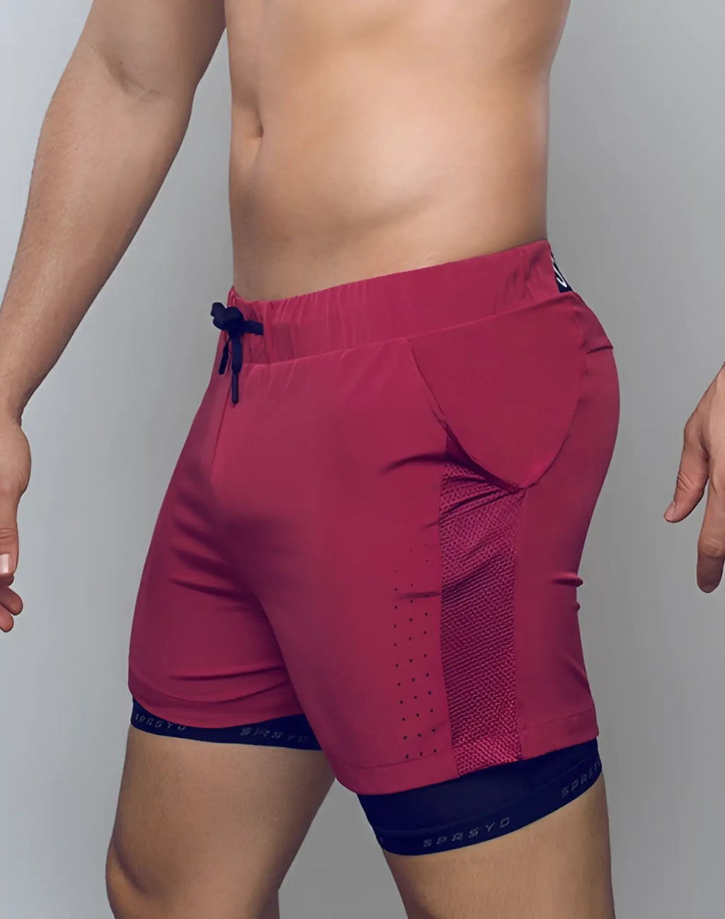 SupaWear SPR Max redbud athletic shorts with navy drawstring mesh paneling and Sprzyo branded waistband