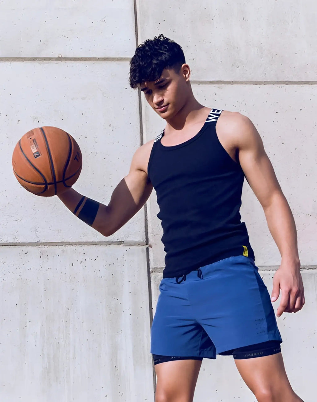 Orange basketball with black seams and visible logo shown alongside supawear spr max singlet in black
