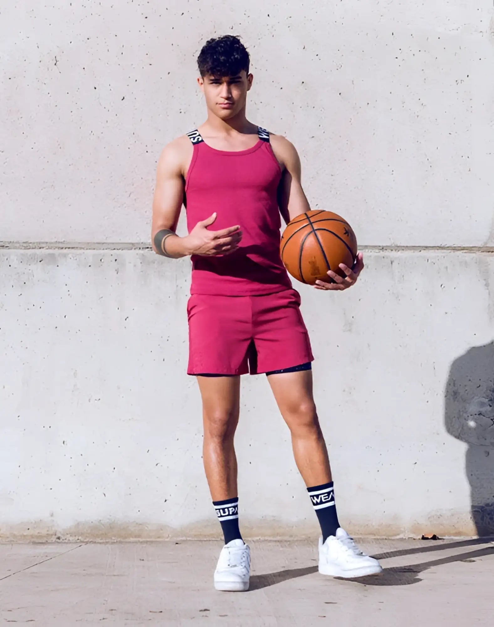 Orange leather basketball paired with supawear spr max singlet in redbud color for athletic performance