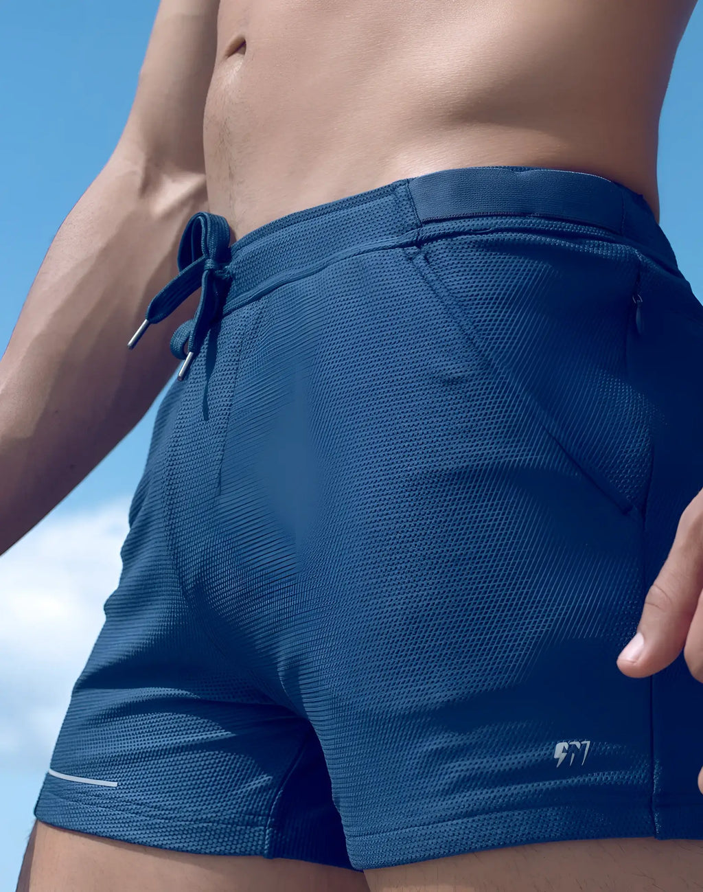 SupaWear SPR mesh shorts in dark blue featuring a textured weave, drawstring waistband, and white piping along the hem
